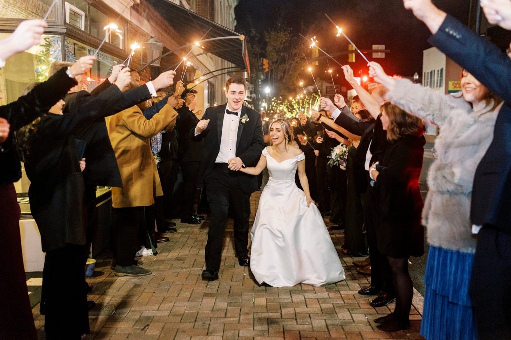 couple laughs through sparkler exit from the Hotel Concord wedding reception 