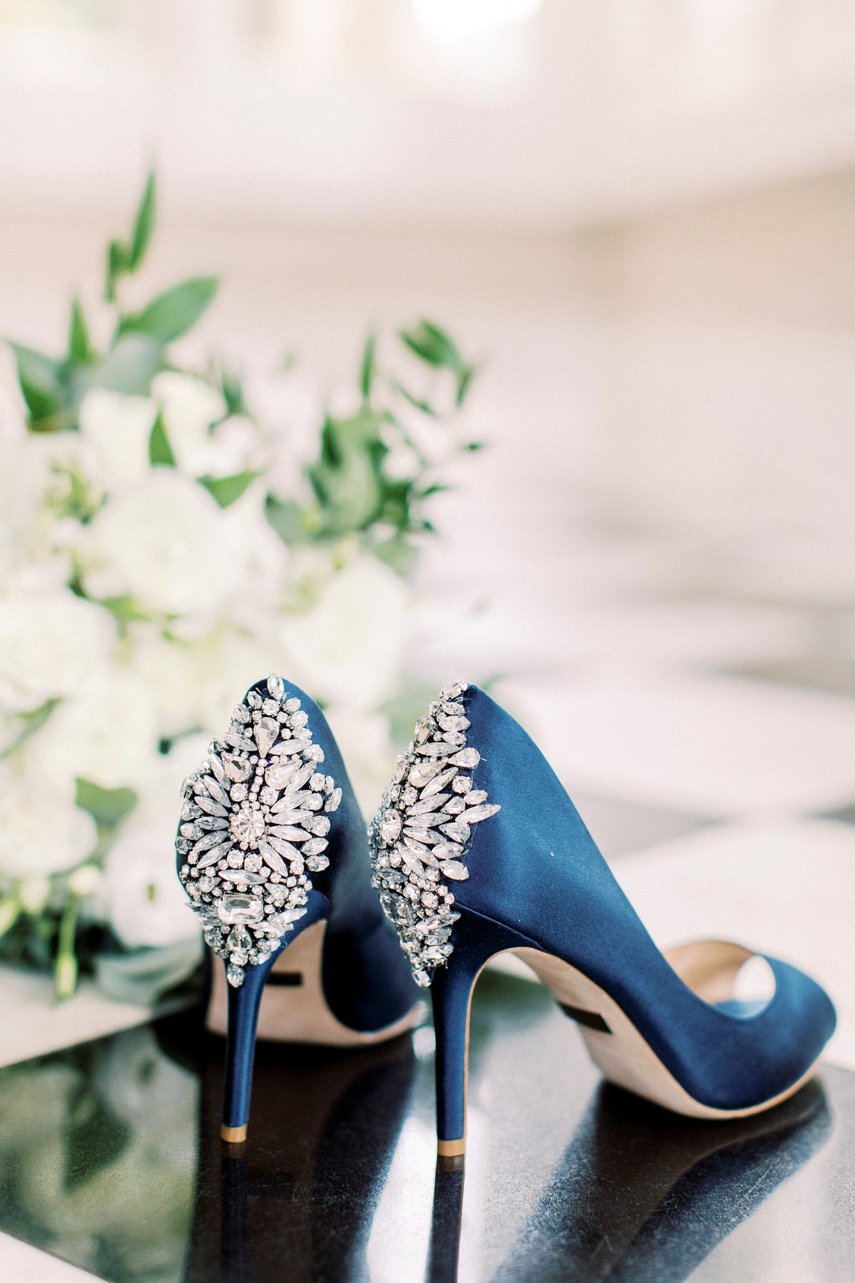 bride's blue shoes with jeweled details on the back
