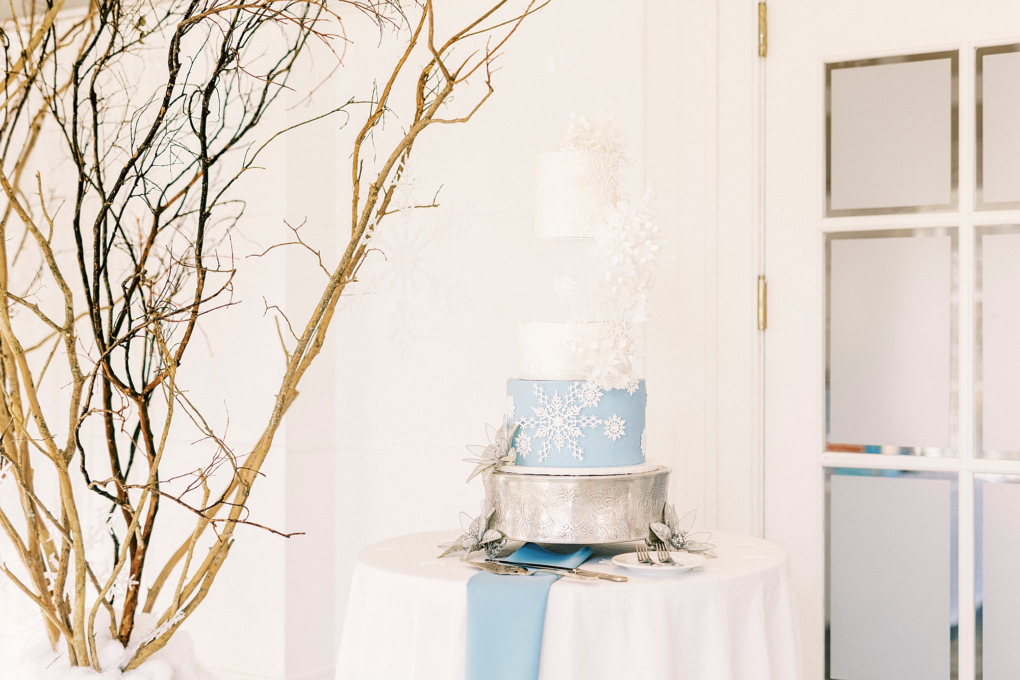 tiered wedding cake with blue and white snowflakes