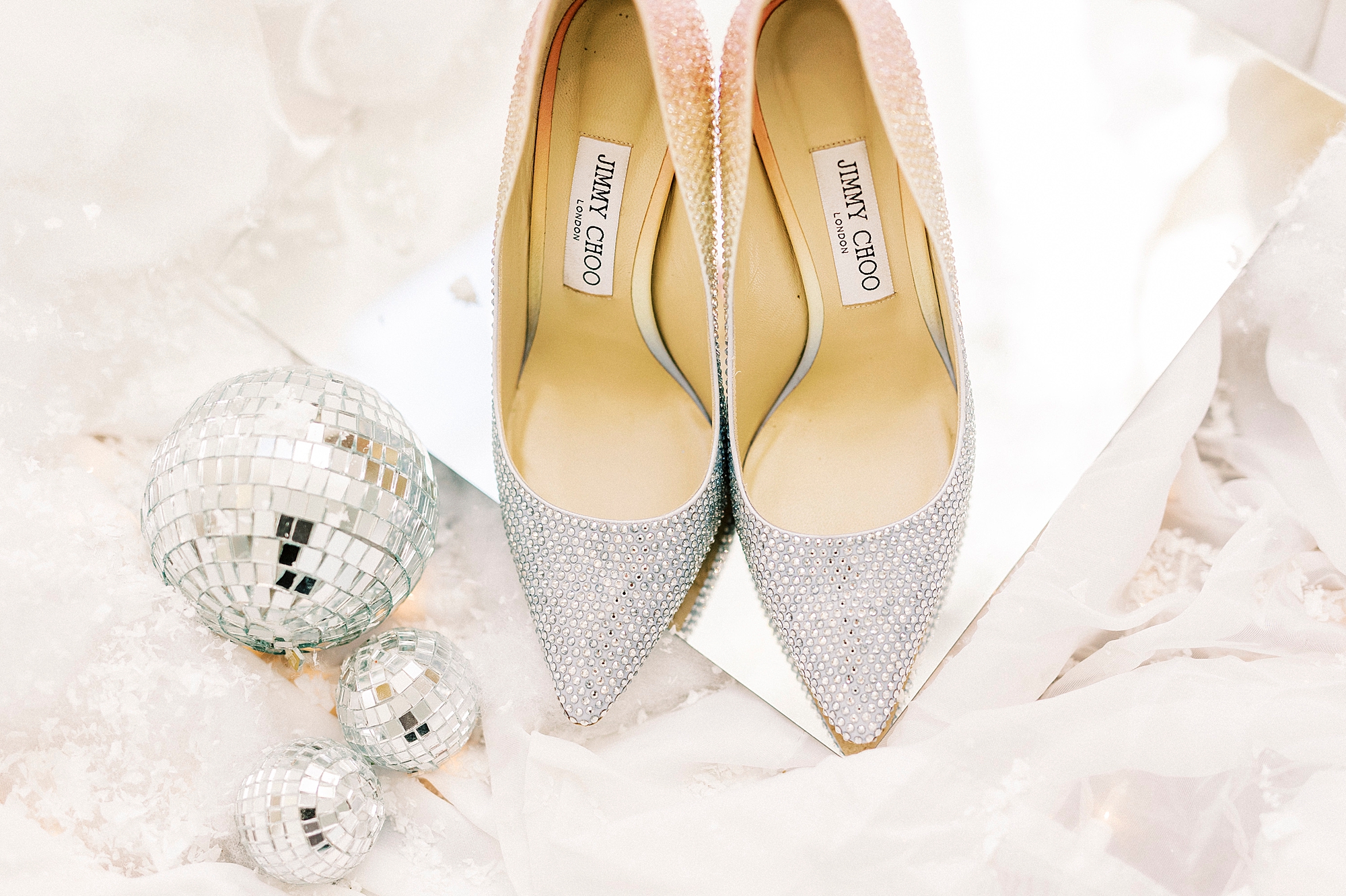 bride's silver shoes for winter wonderland wedding at River Run Country Club