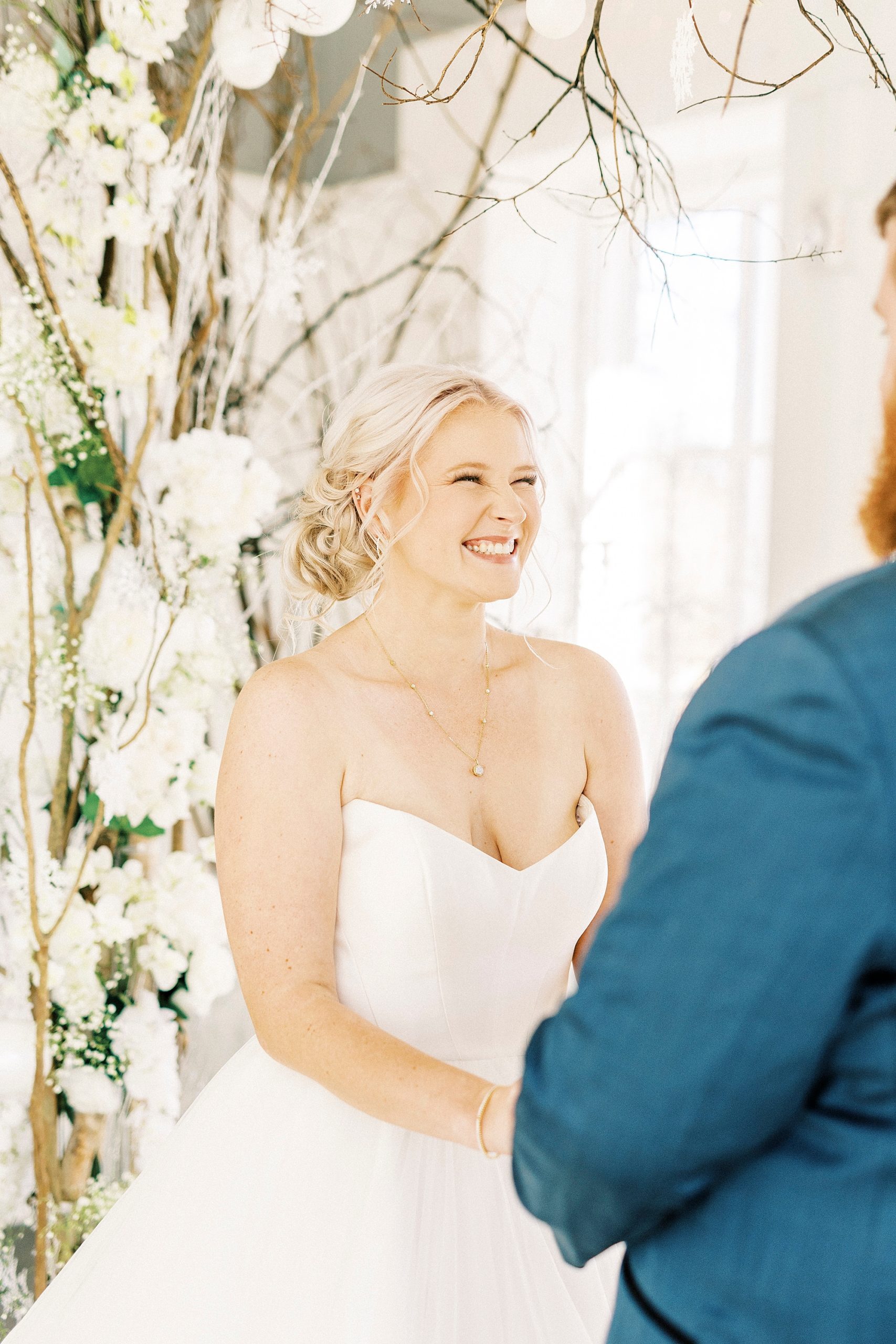 bride smiles at groom during ceremony at River Run Country Club 