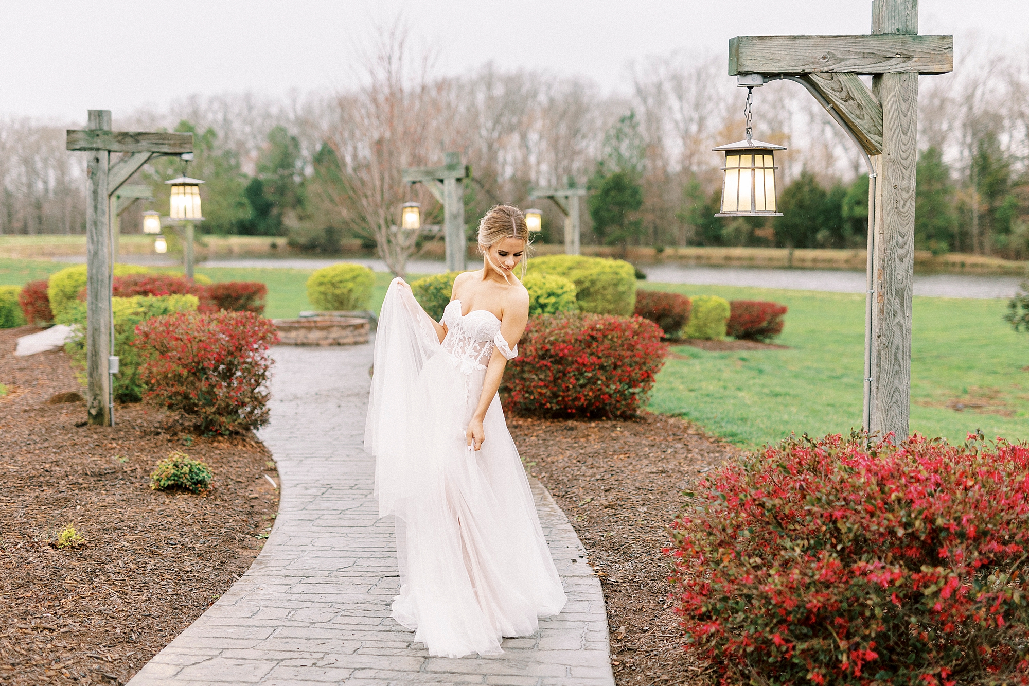 bride twirls with wedding dress skirt lifted in gardens 