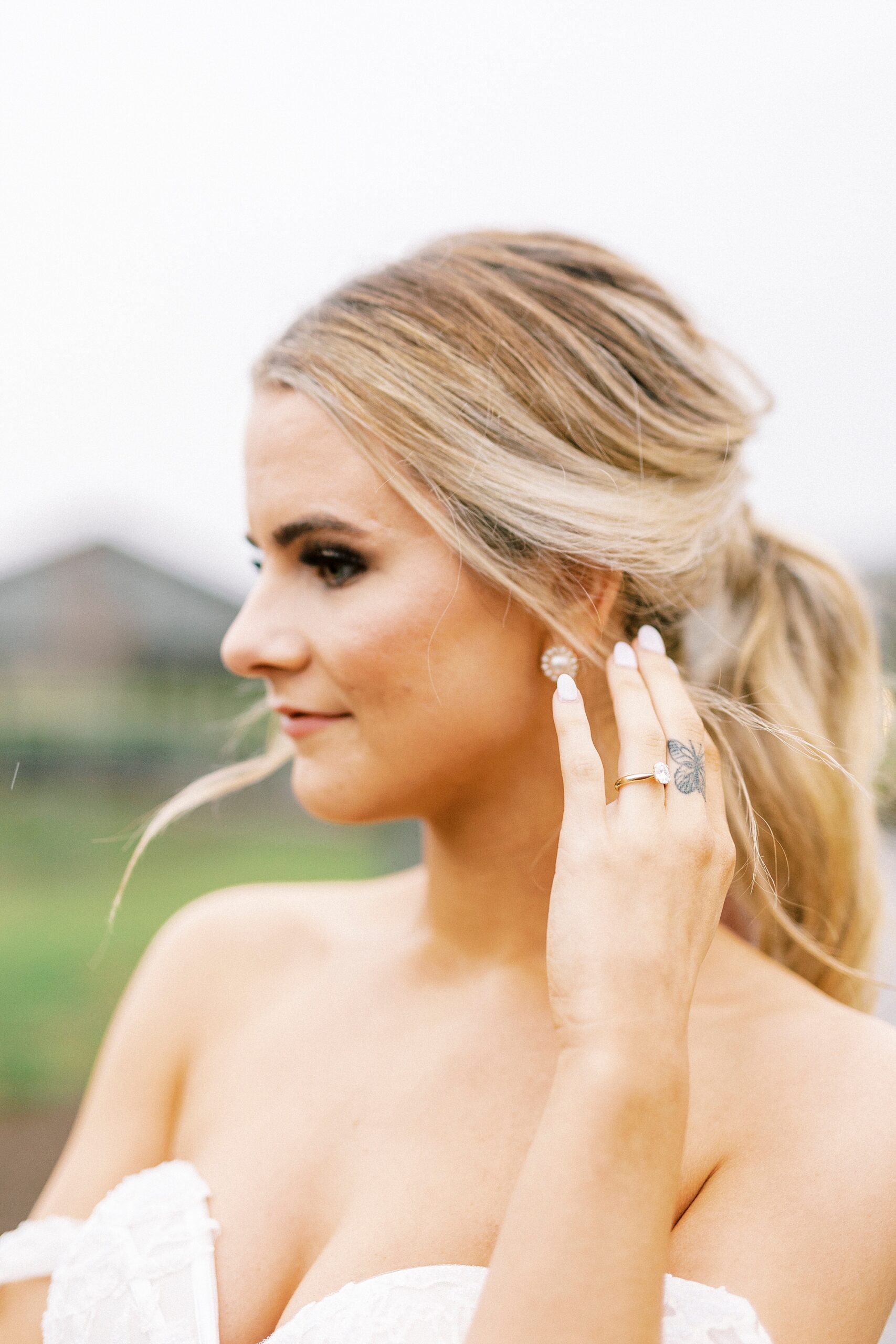 bride pushes hair over ears 