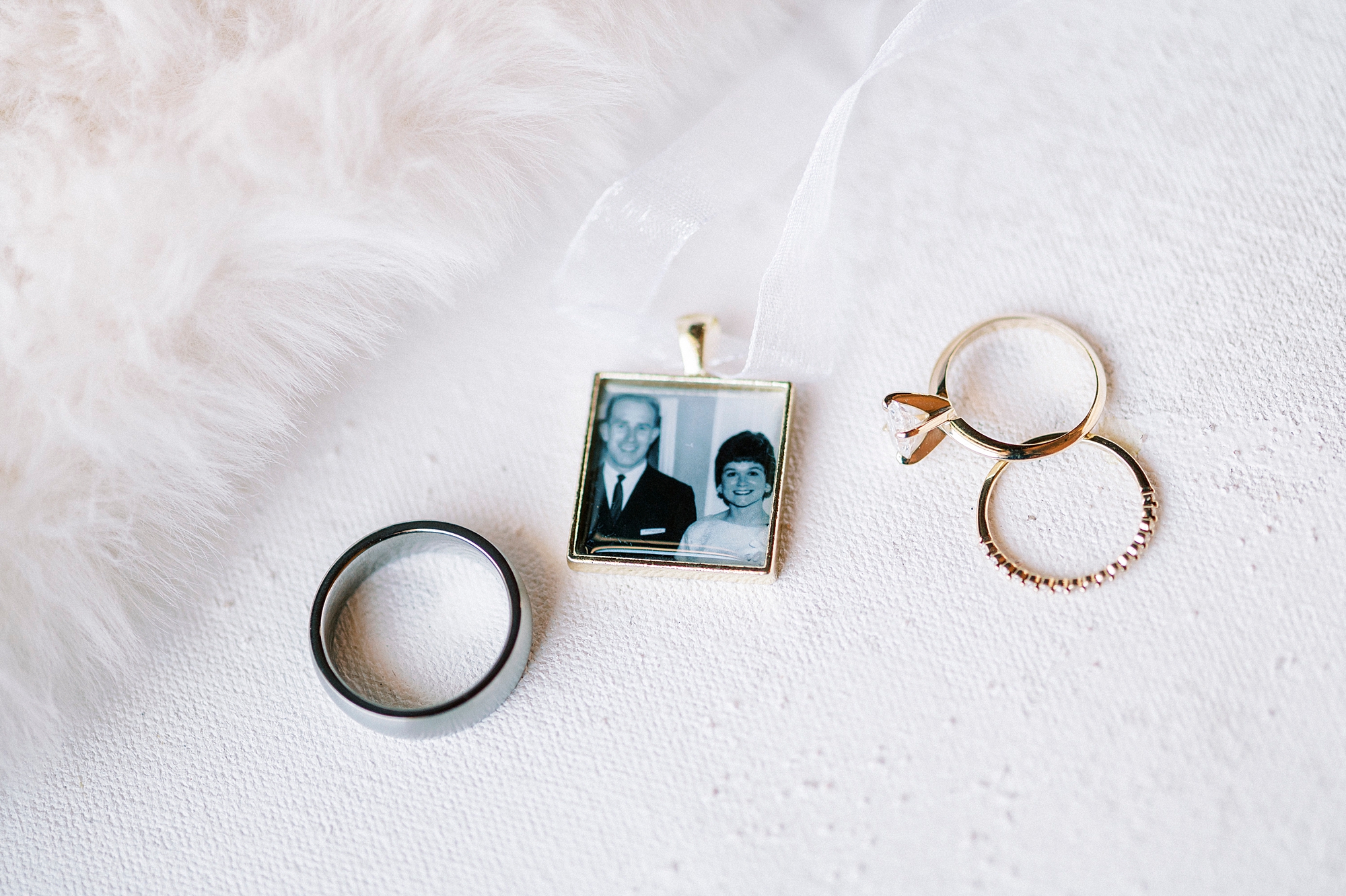 wedding rings lay with photo for bride's bouquet 