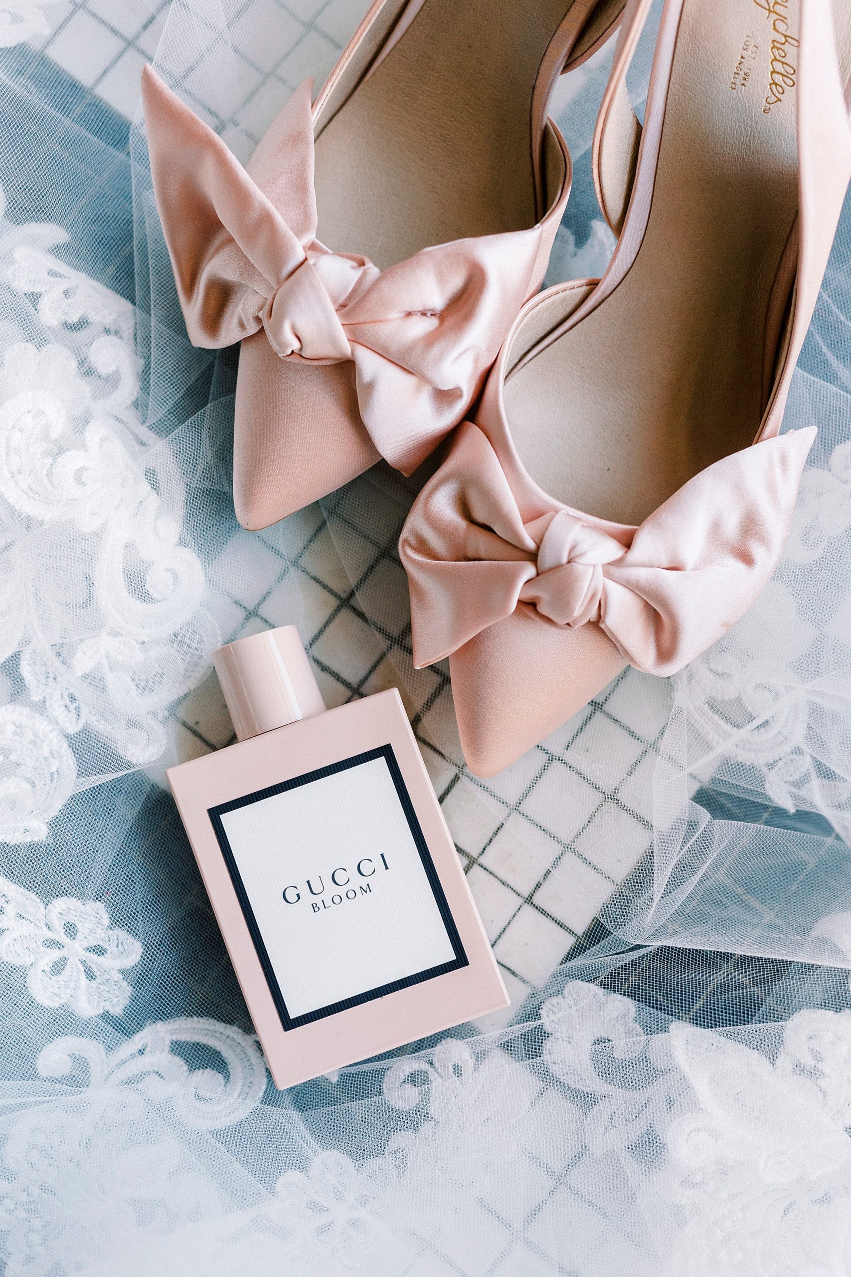 bride's pink shoes and perfume bottle for Cadillac Service Garage wedding 