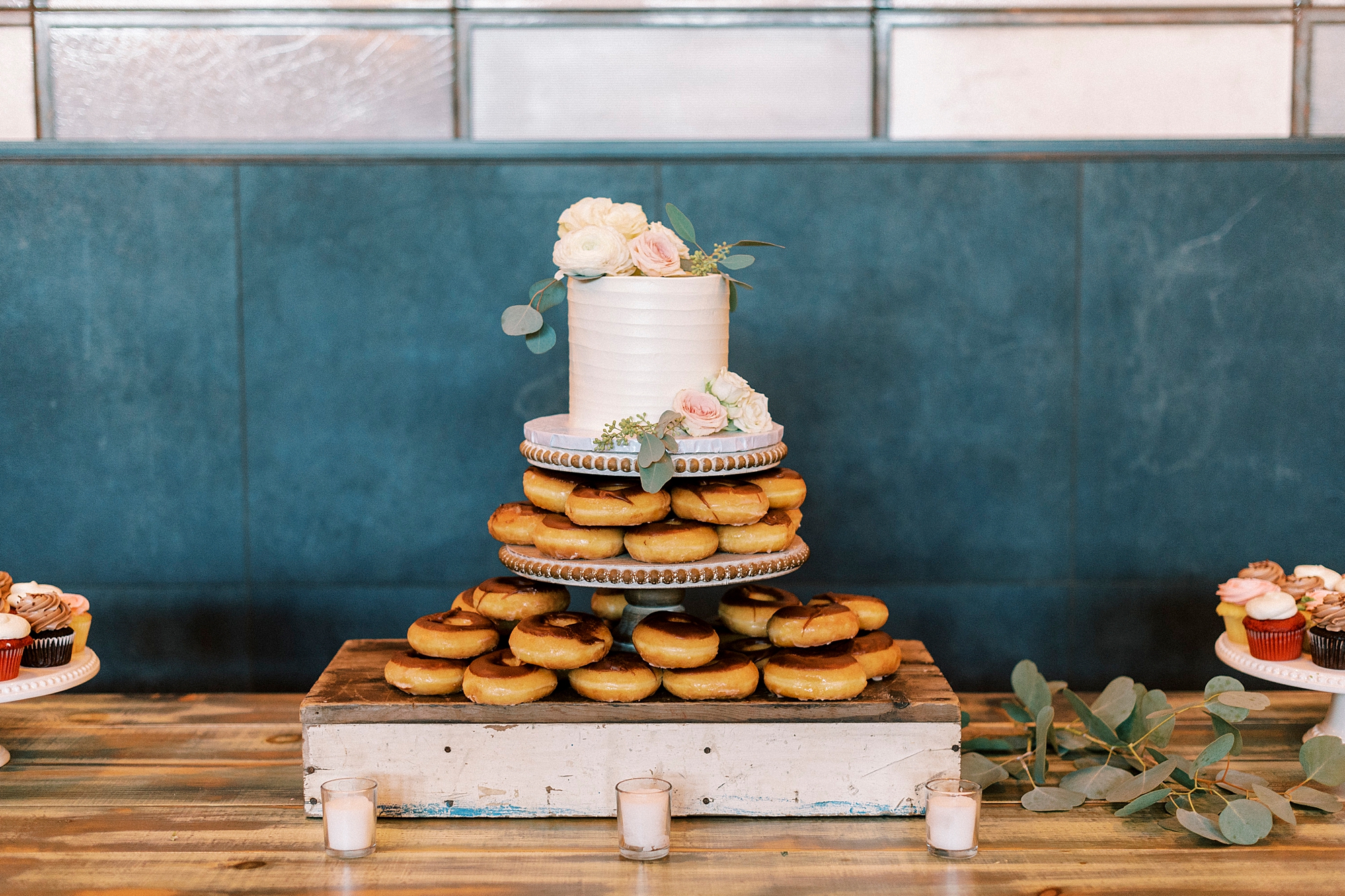 cake sits on top of two tiers of donuts 