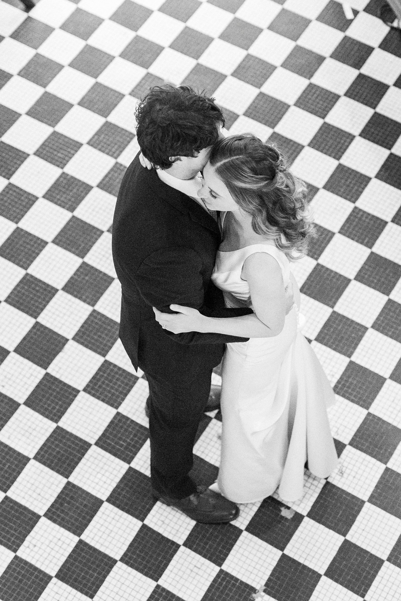 bride and groom dance on black and white floor at Greensboro NC wedding reception 