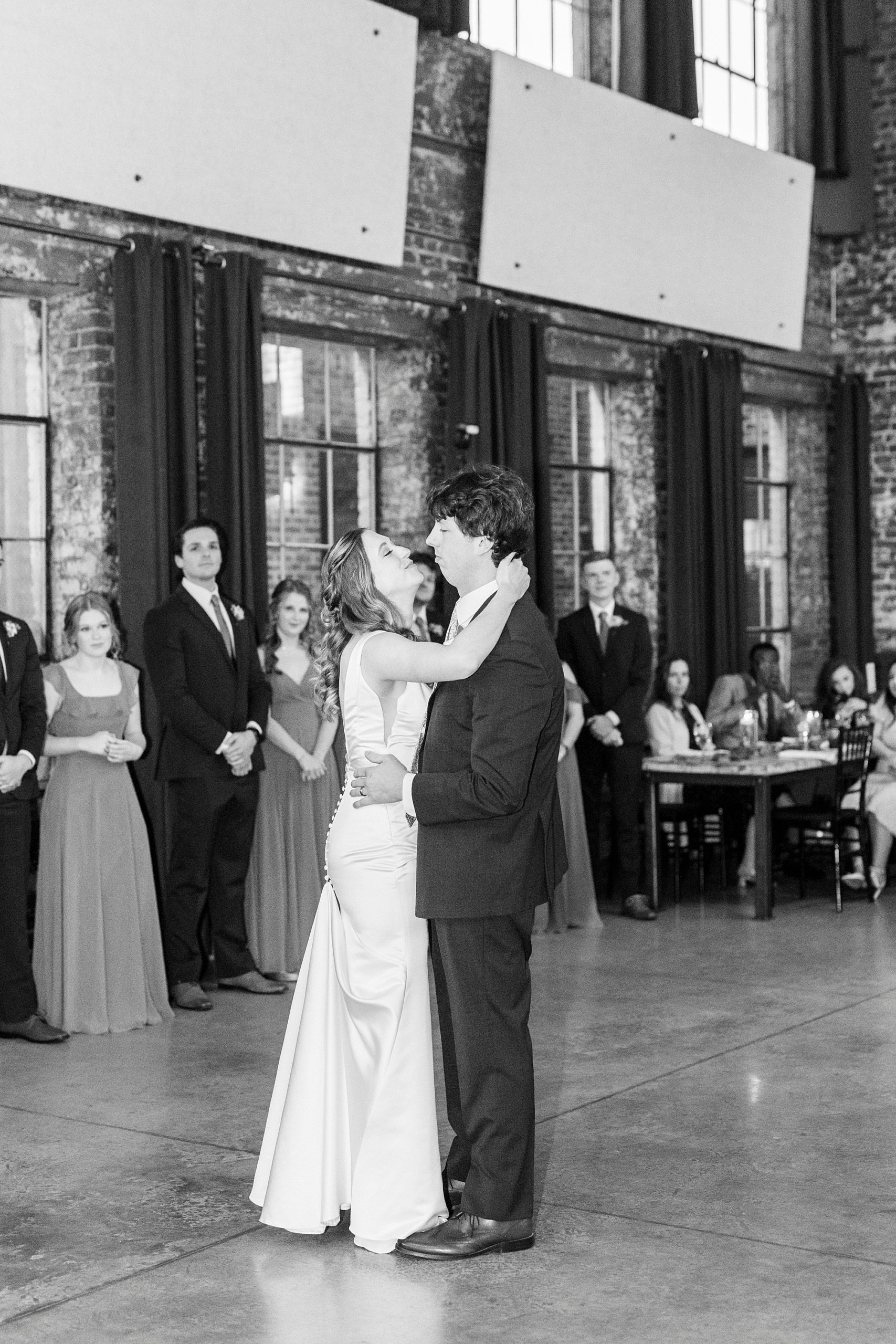 bride laughs dancing with groom during Greensboro NC wedding reception 