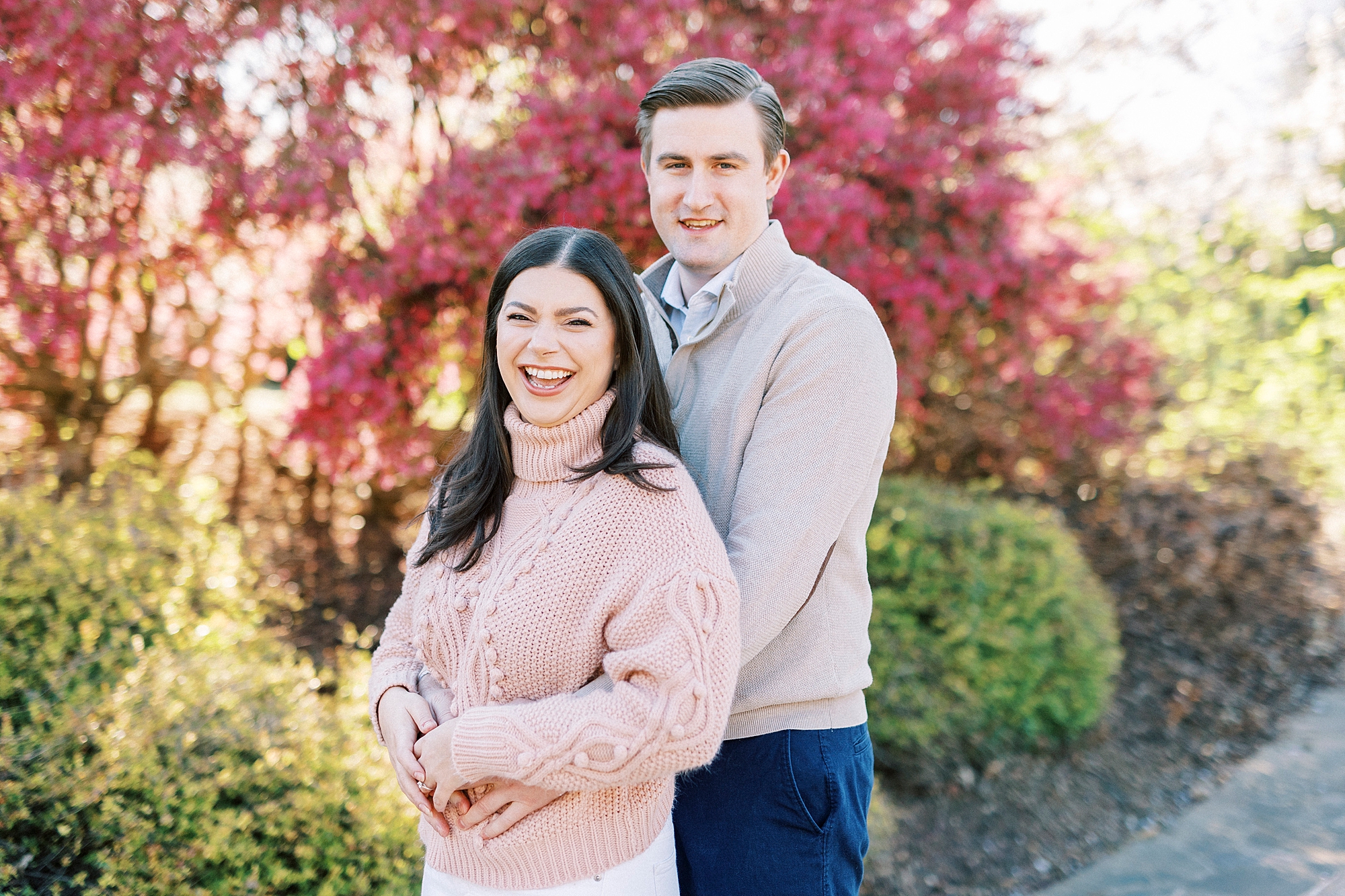 engaged couple hugs in sweaters in spring Elizabeth Park engagement session 