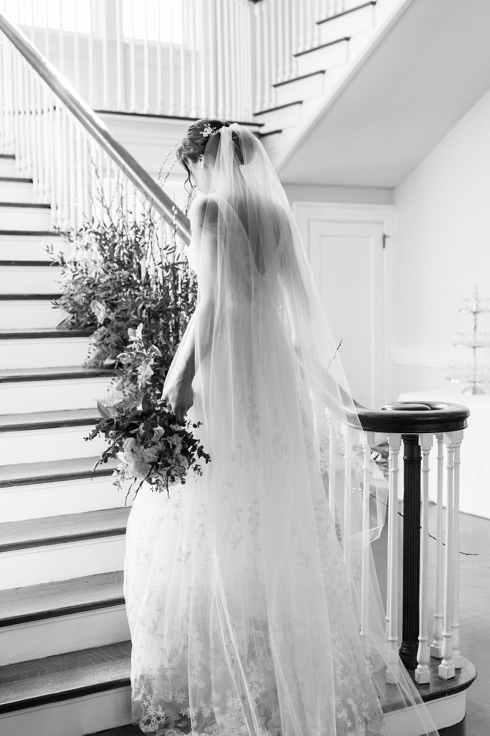 bride walks up steps with veil behind her at Separk Mansion