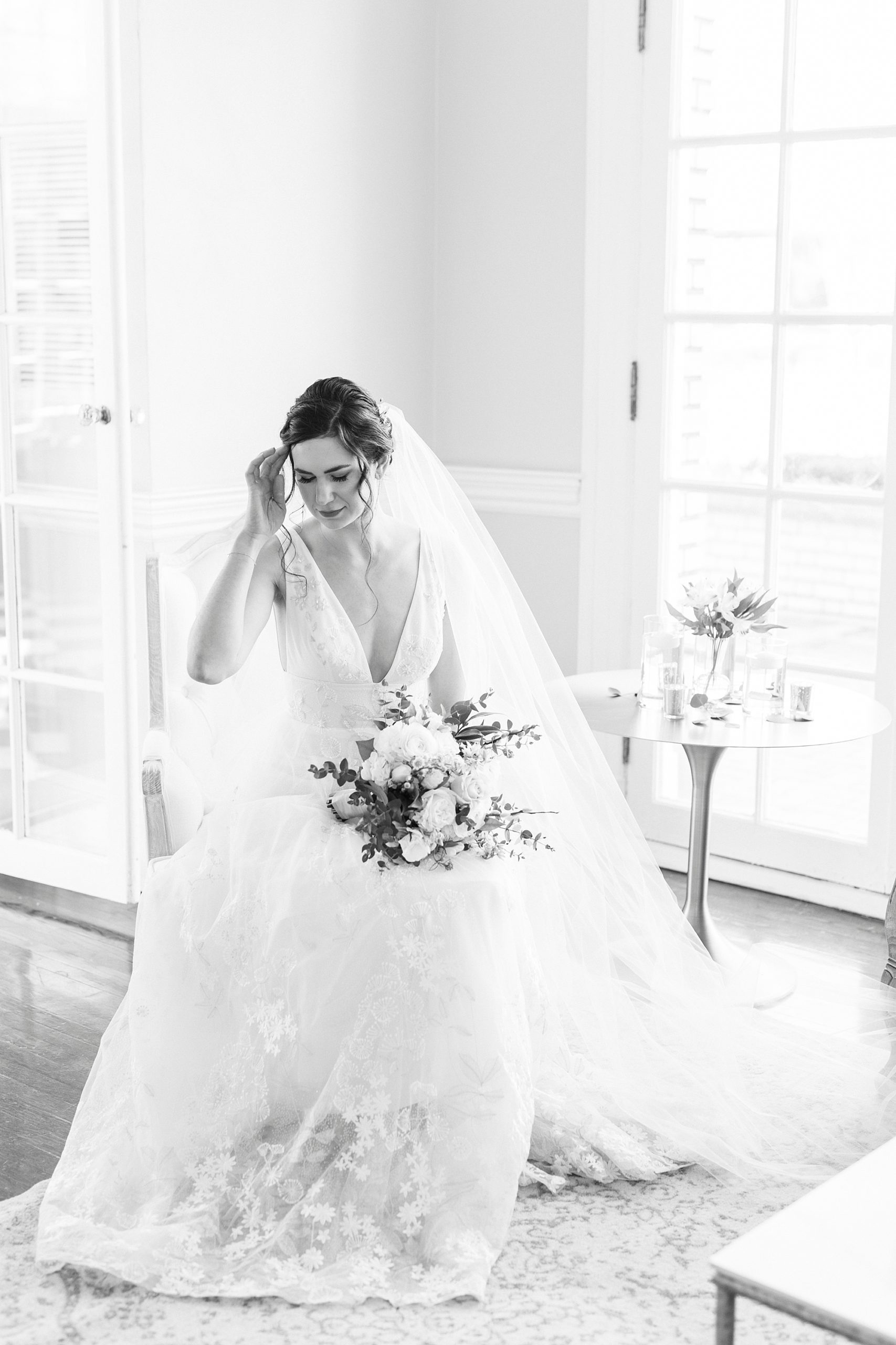 bride brushes hair behind her ear sitting in lobby at Separk Mansion