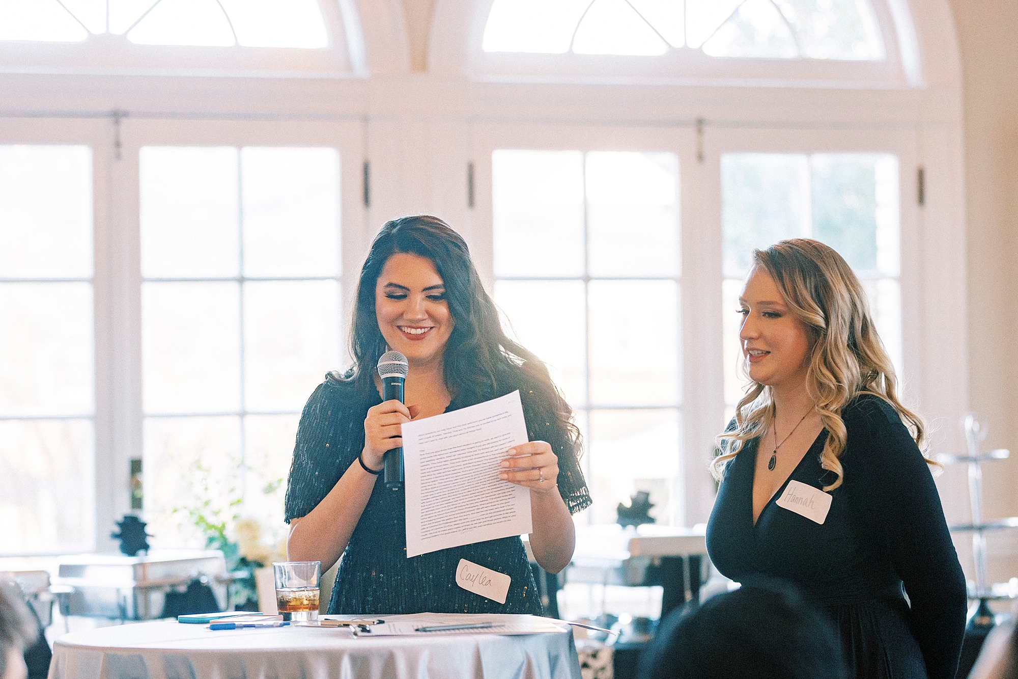 woman reads speech during tasting event 