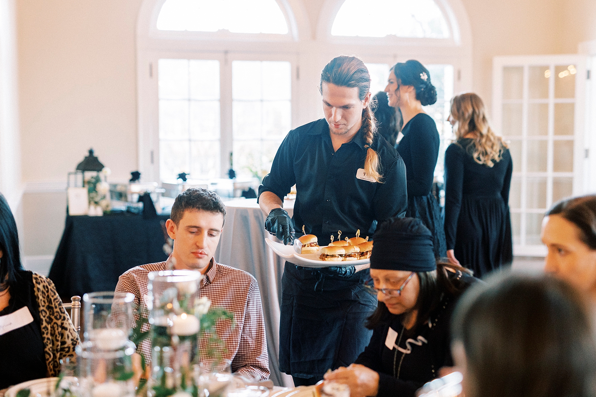 caterers serve couples during Grand Tasting Event at Separk Mansion in winter 2023 