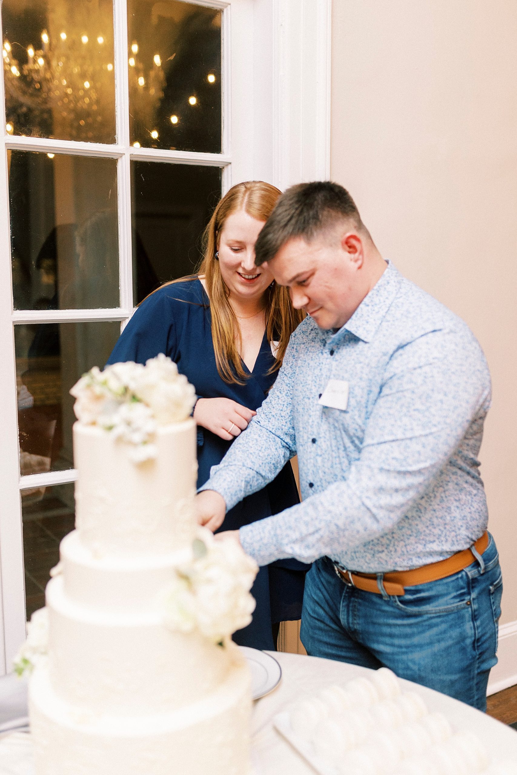 couple cuts wedding cake during Grand Tasting Event at Separk Mansion in winter 2023 