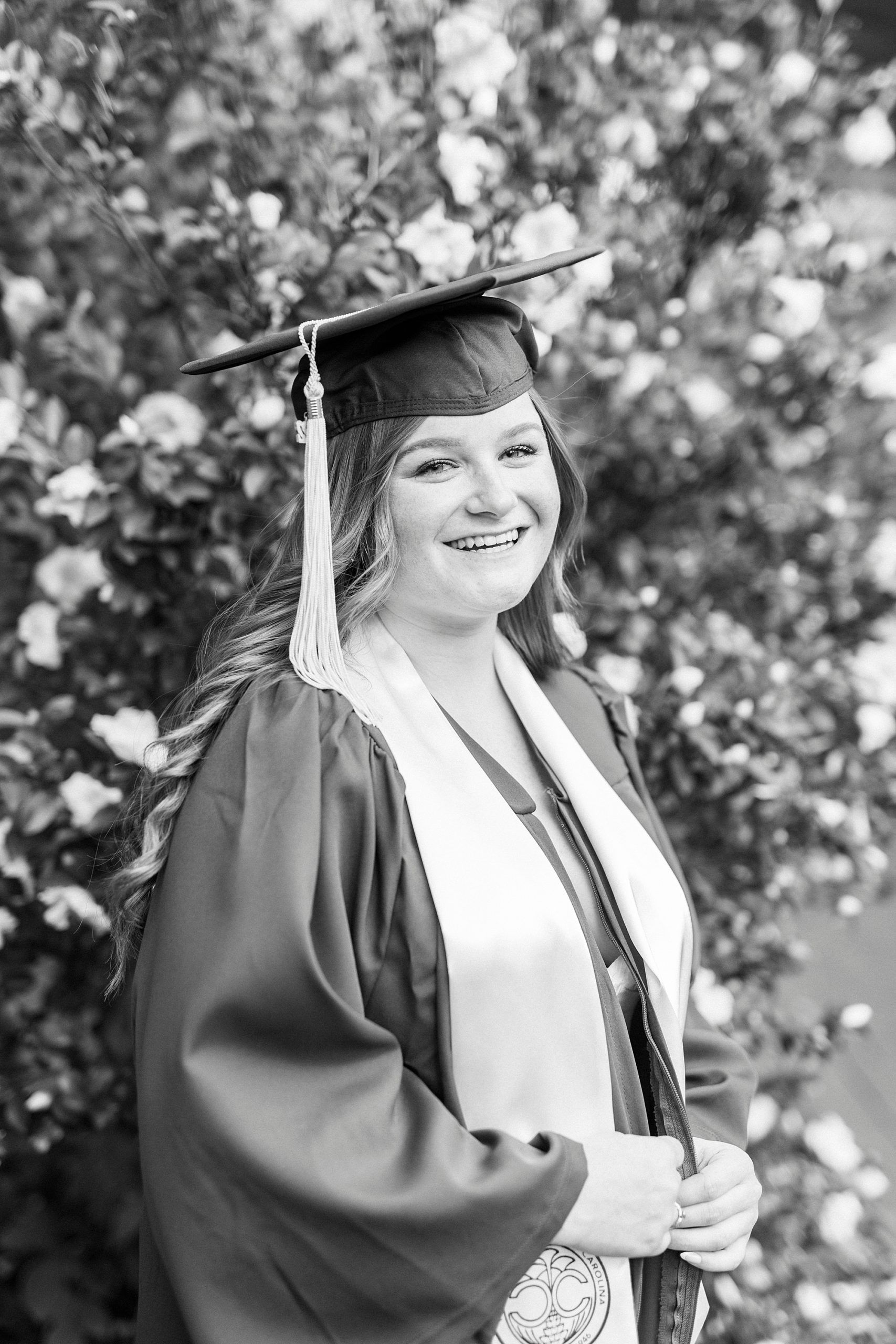 UNC Charlotte senior portraits for woman in cap and gown
