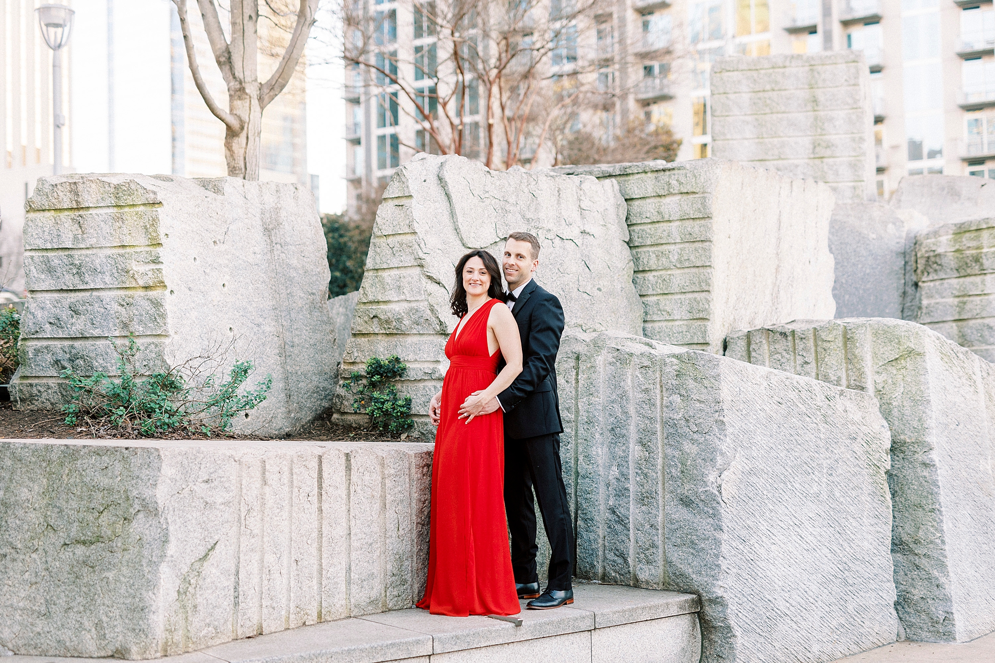 couple poses by fountain at Romare Bearden Park