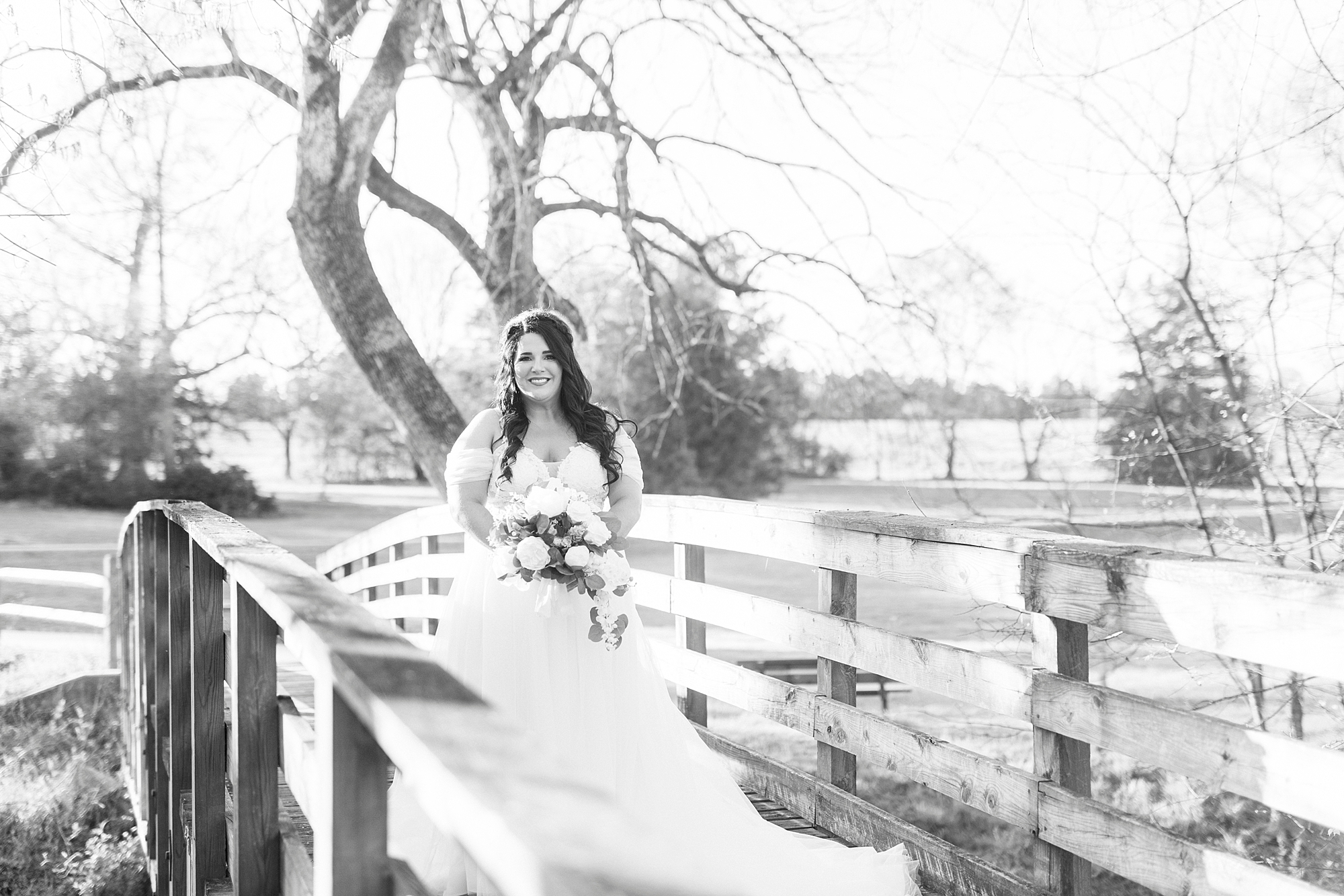 black and white portrait of bride on wooden bridge in Sloan Park