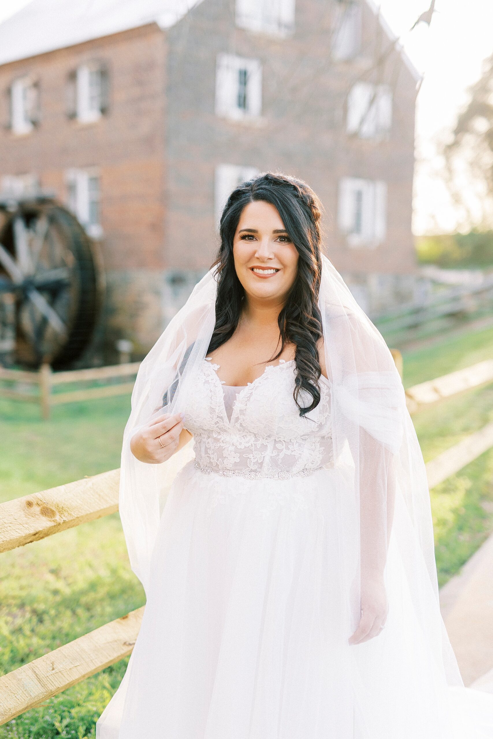 bride grins with veil around shoulders in Sloan Park