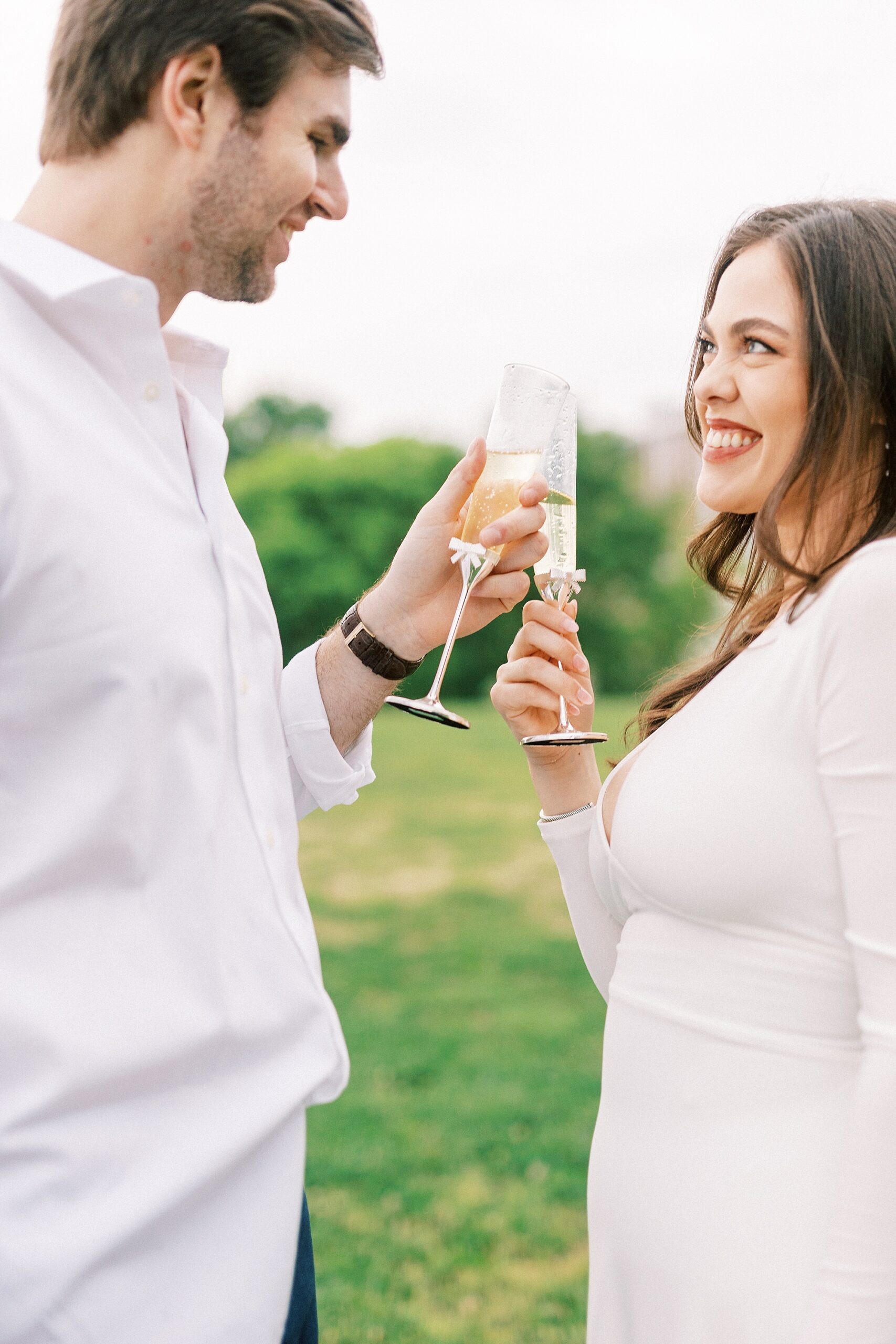 engaged couple toasts Champagne in Midtown Park