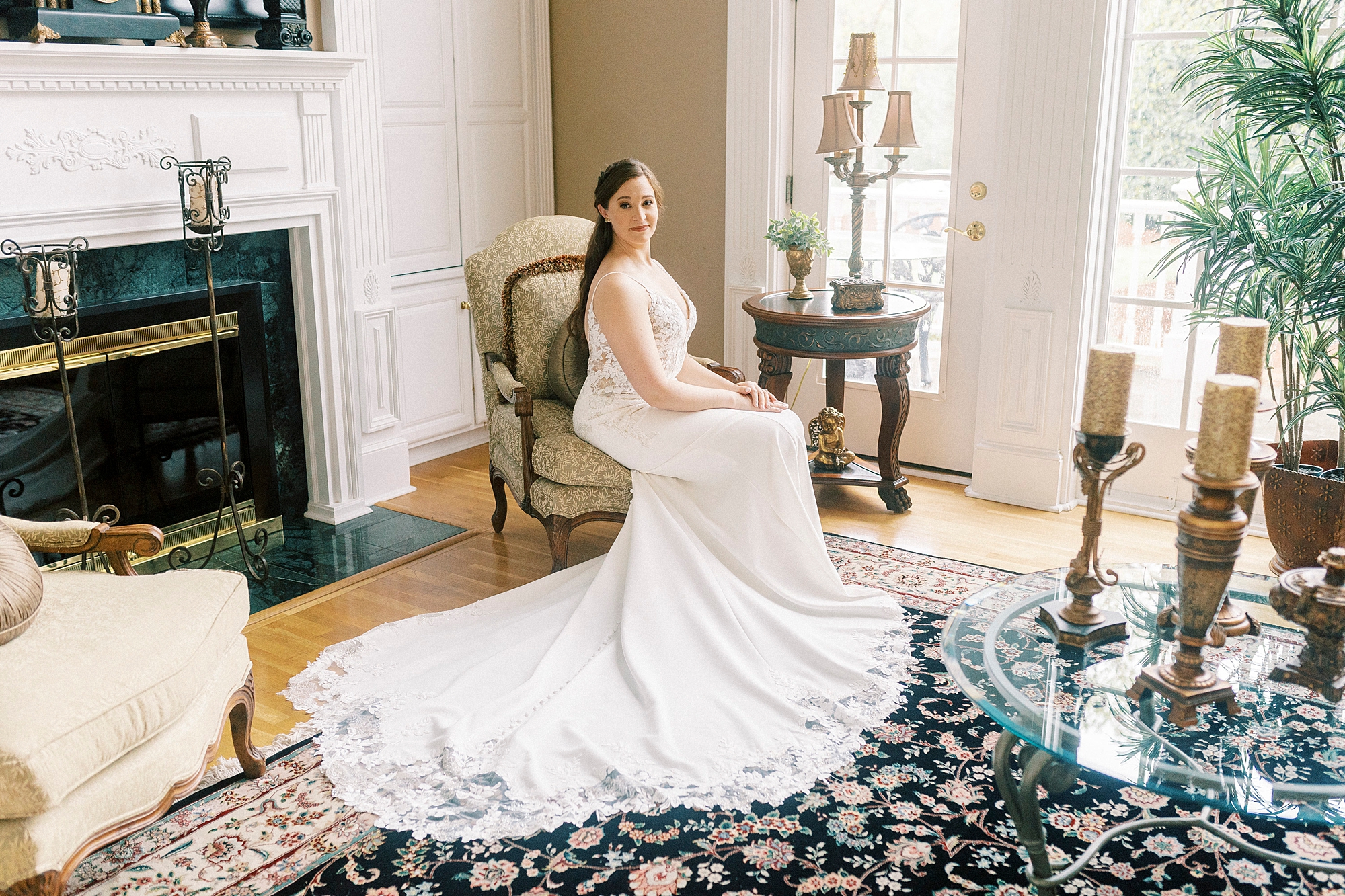 bride sits in gold chair by fireplace in sitting room at The Saratoga Springs