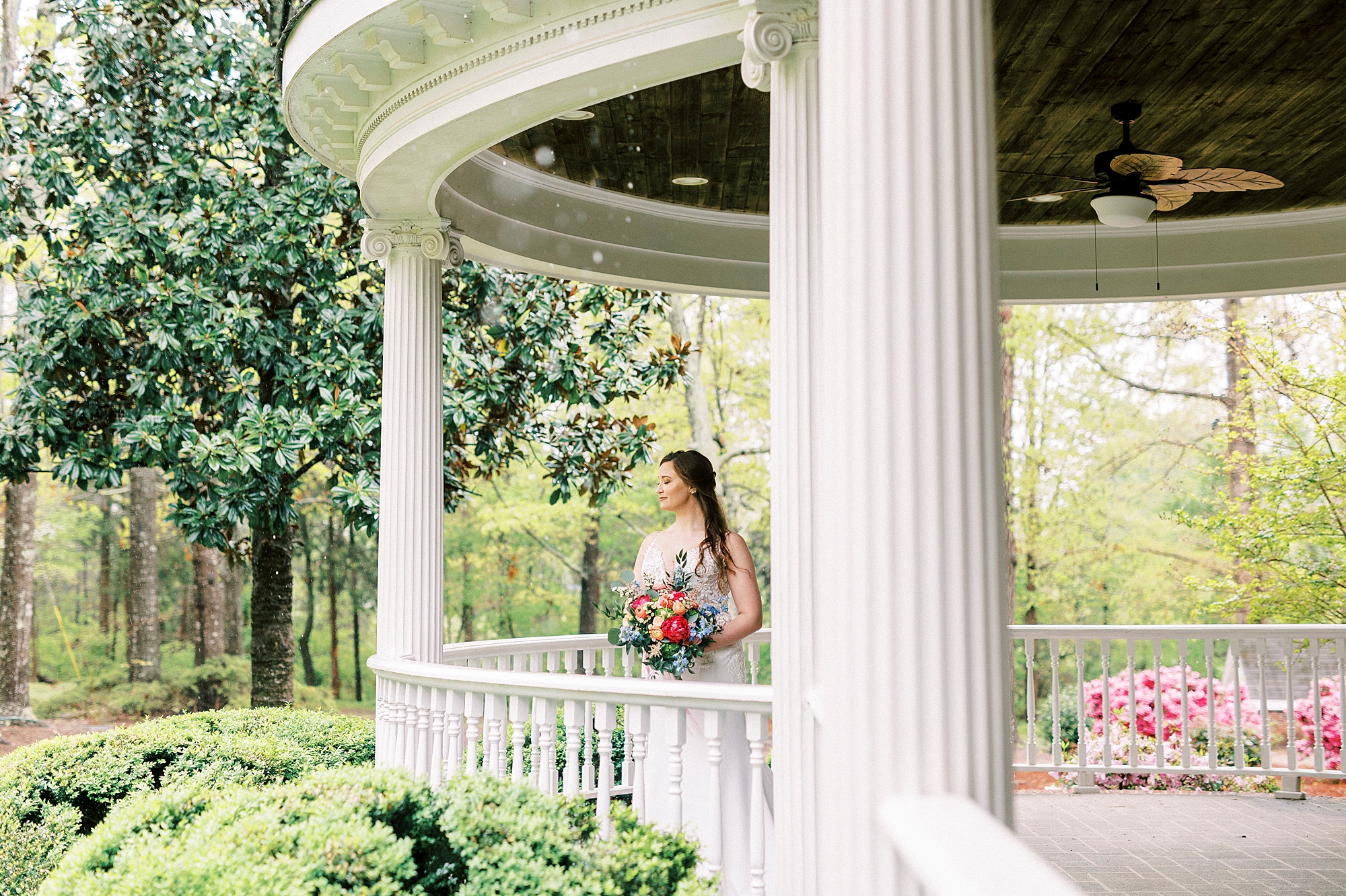 bride stands on patio at The Saratoga Springs in Charlotte NC