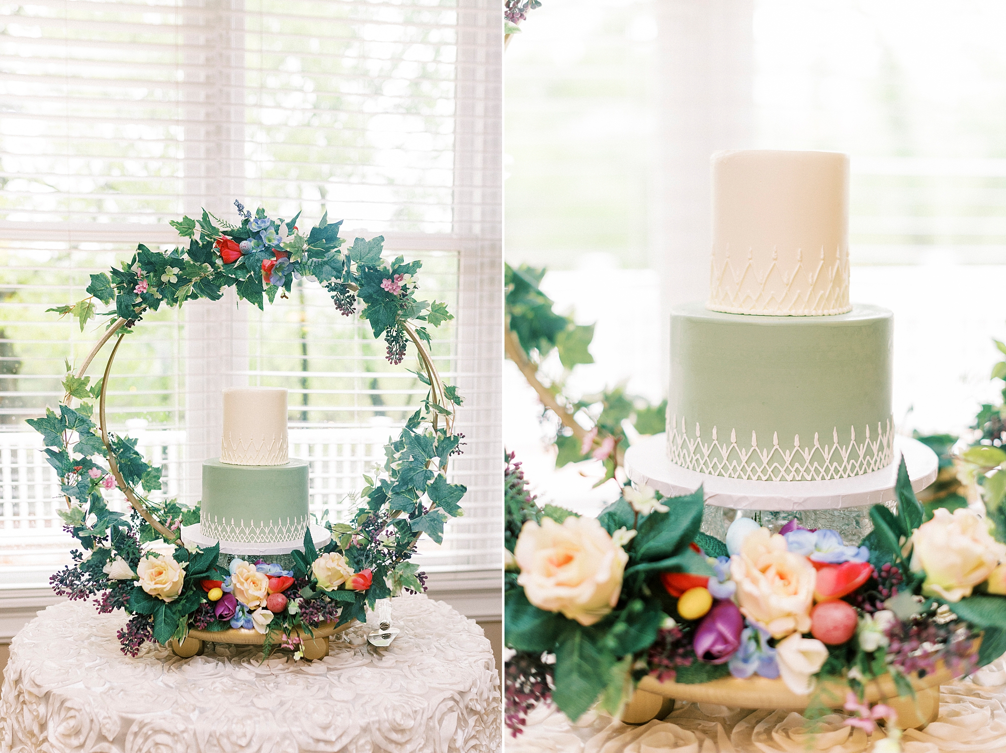 tiered wedding cake with green and white accents under floral arbor 