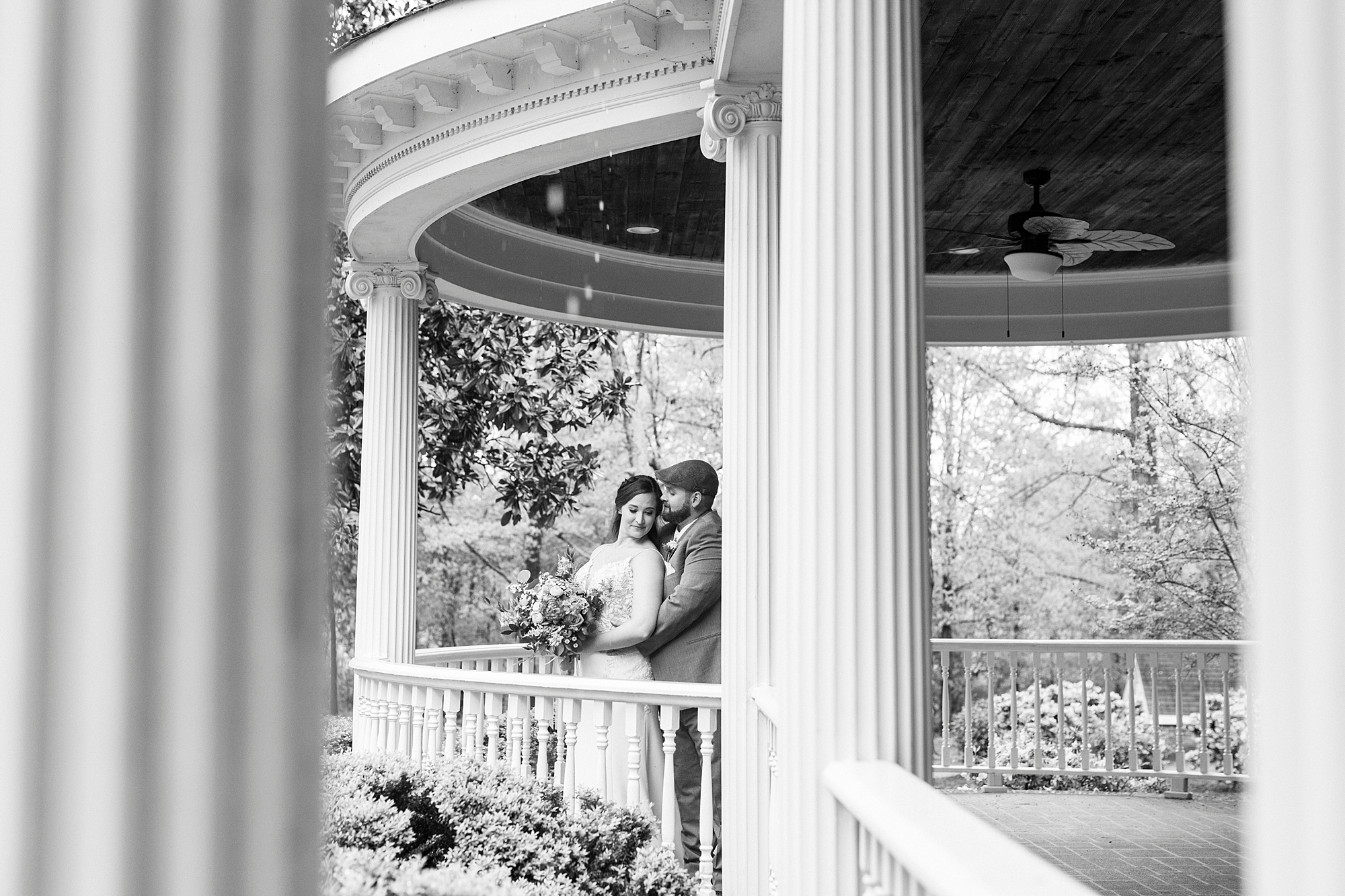 bride and groom hug on porch at The Saratoga Springs