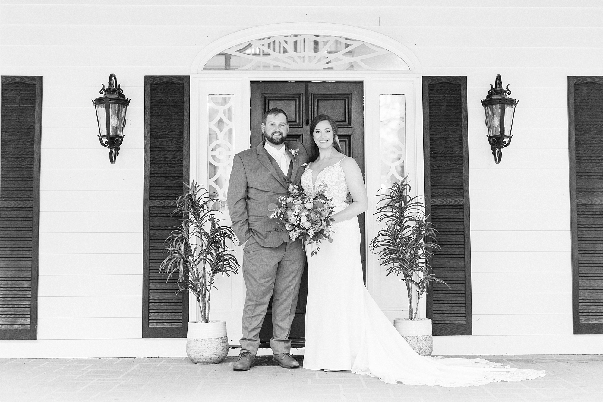 newlyweds stand together in front of doorway at The Saratoga Springs