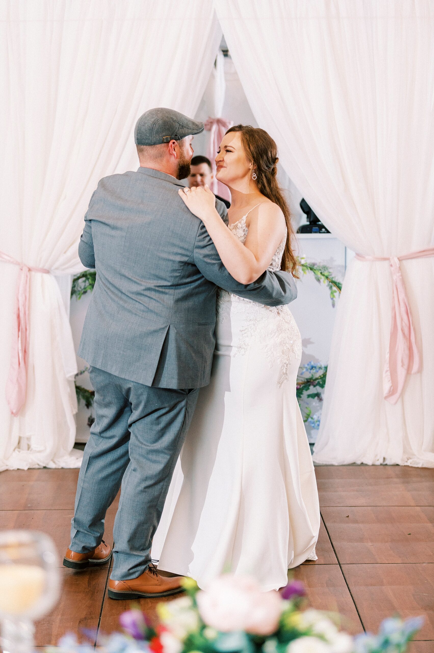 newlyweds dance during tented Charlotte NC wedding reception 