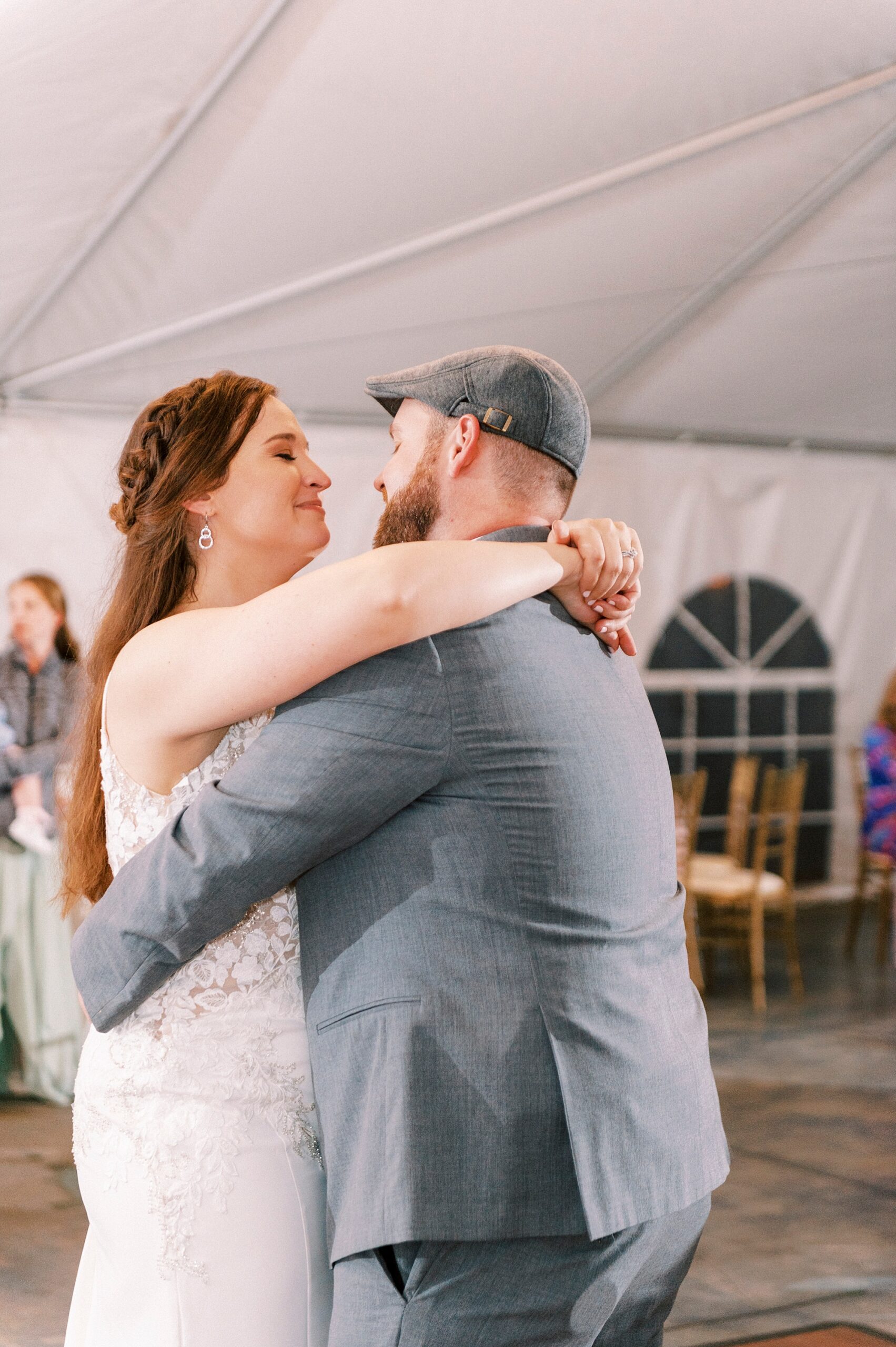 newlyweds hug during first dance at Charlotte NC wedding reception 