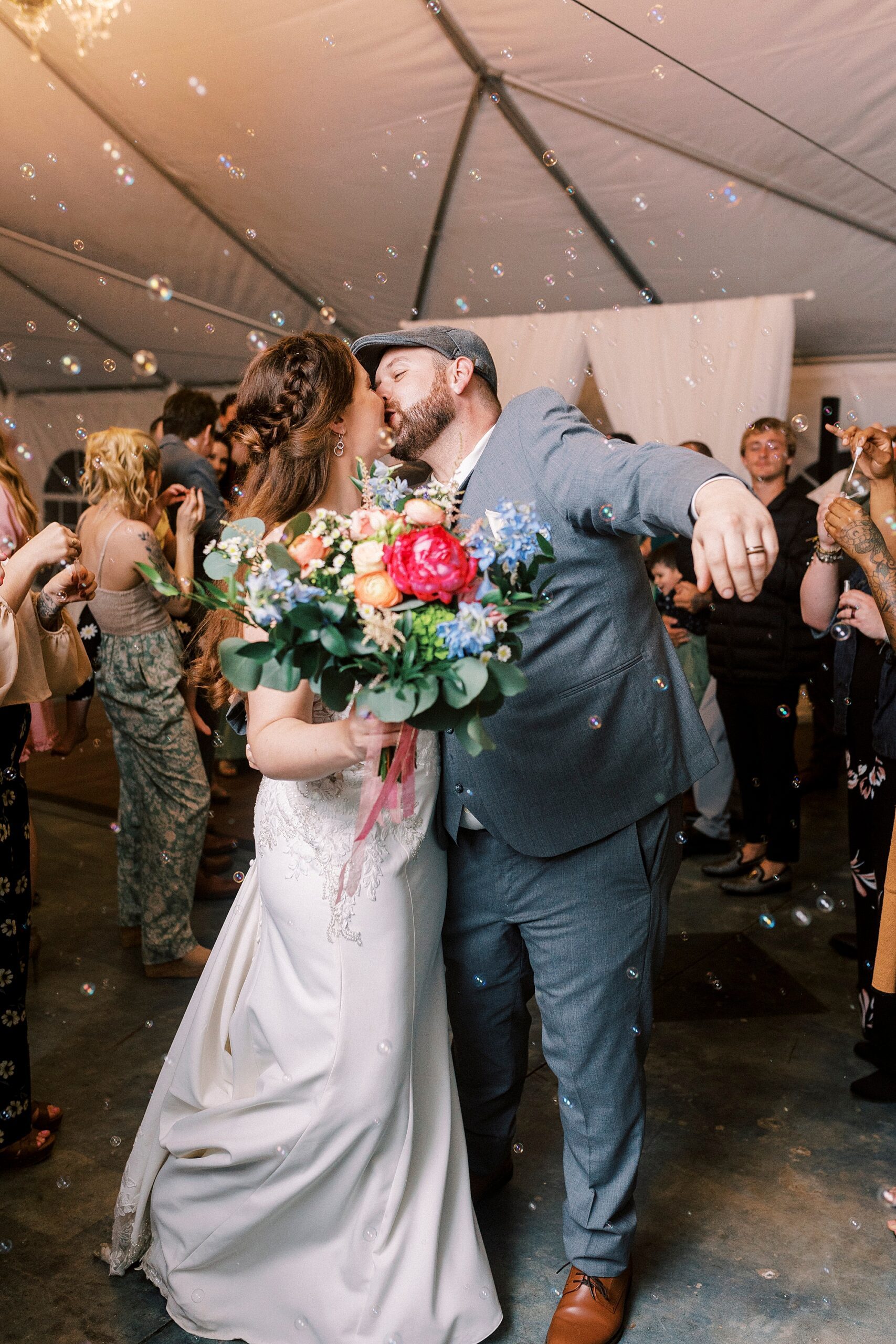 newlyweds kiss during bubble exit from Charlotte NC wedding reception 