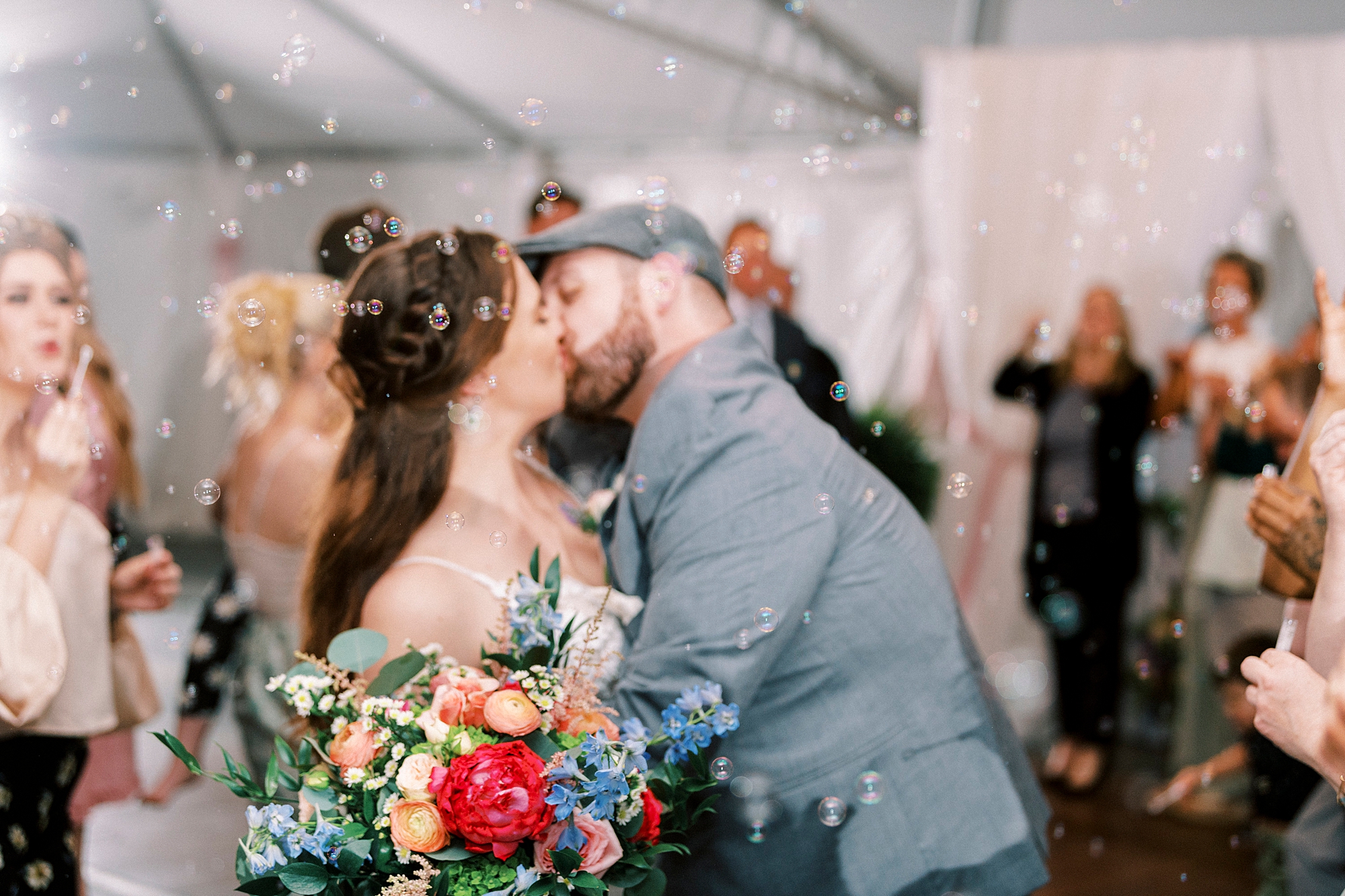 newlyweds kiss during bubble exit from Charlotte NC wedding reception 