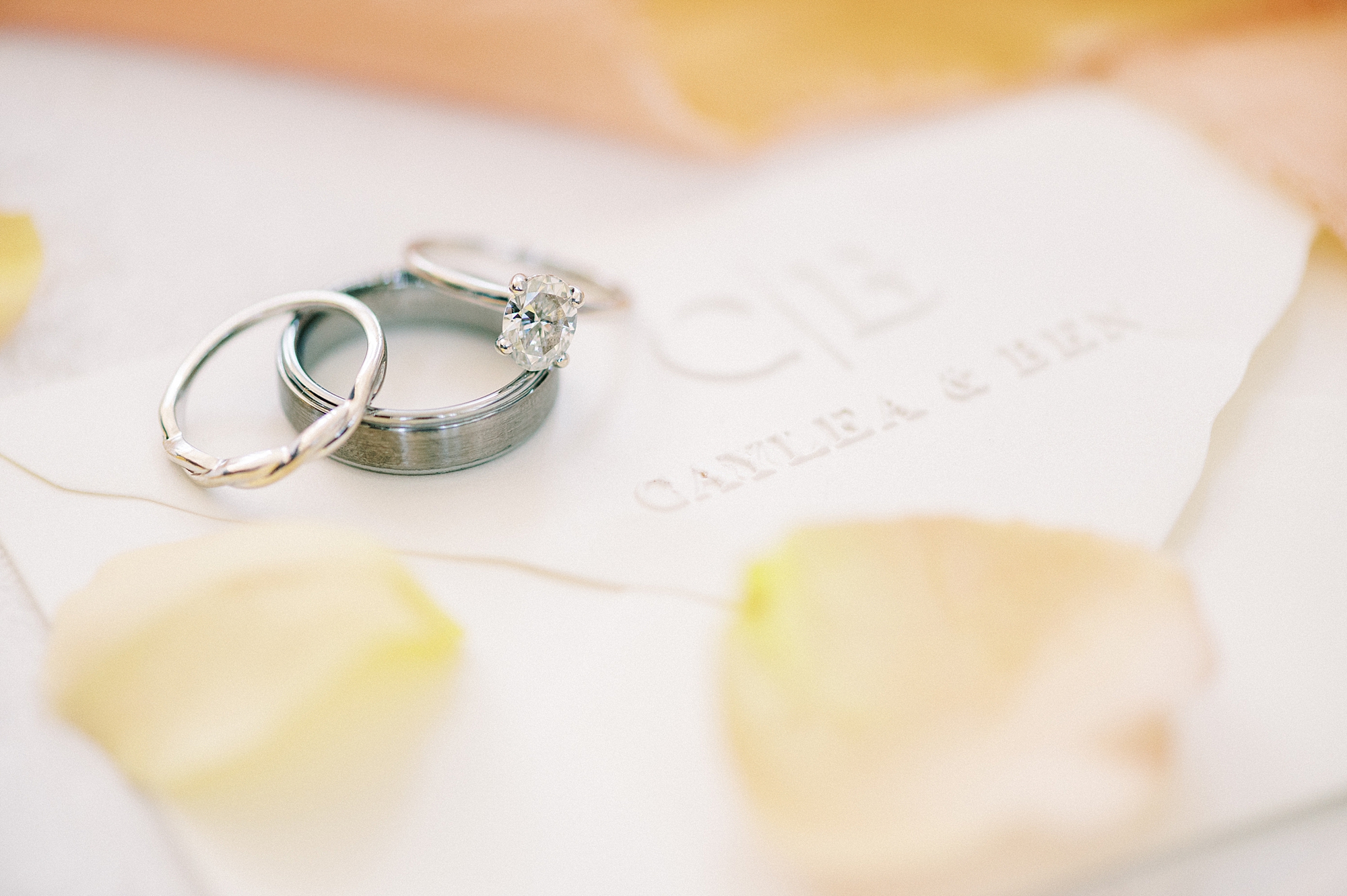 wedding rings lay on envelope with embossed seal 