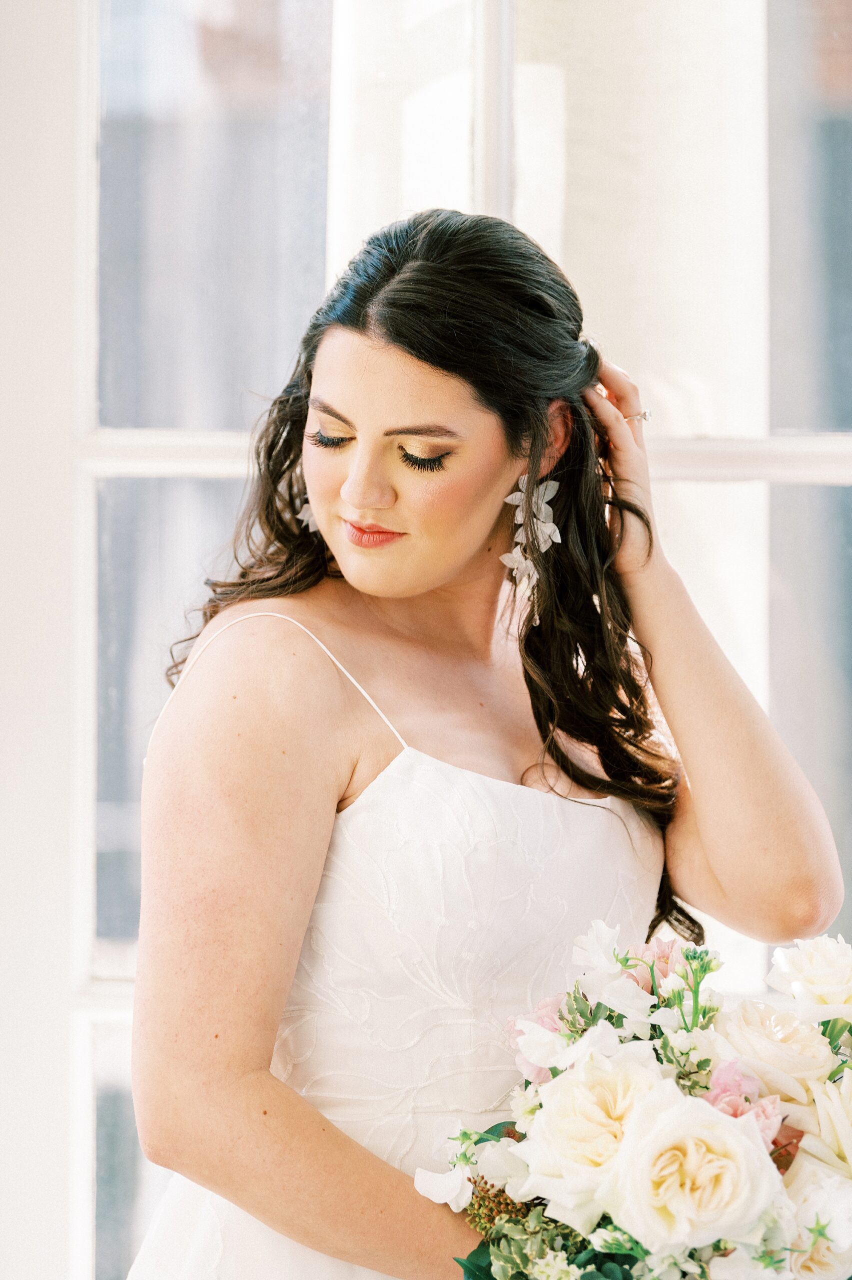 bride pushes hair behind ear during spring Separk Mansion wedding