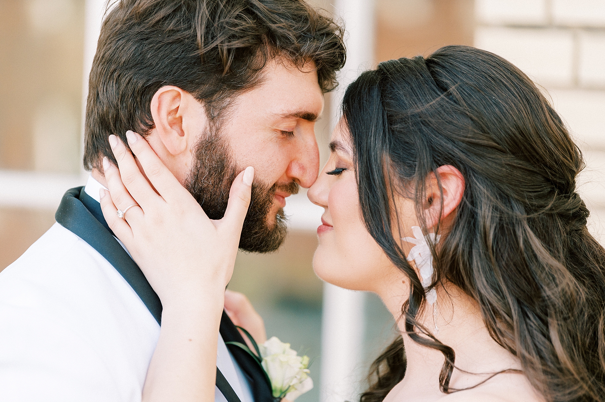 bride and groom lean heads together nuzzling noses on patio at Separk Mansion