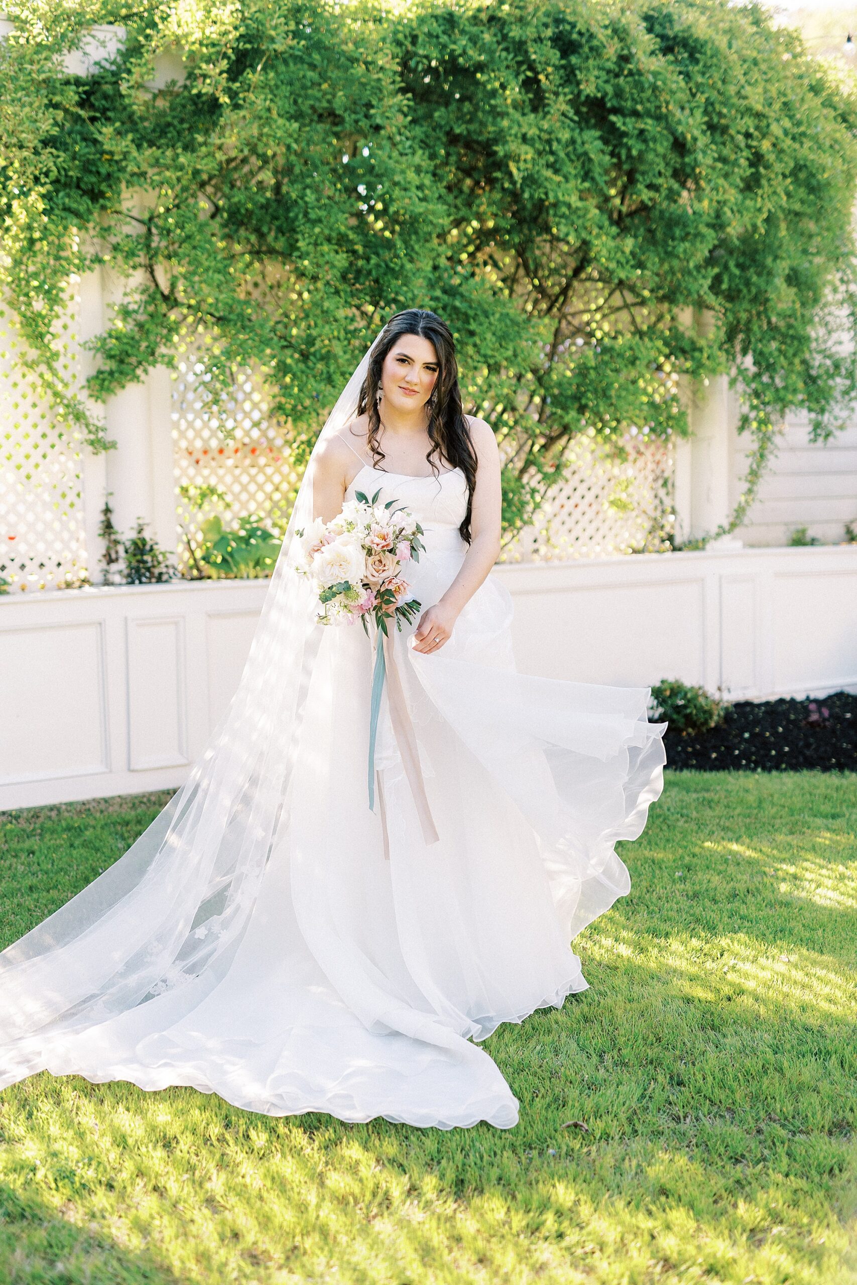 bride tosses wedding dress skirt in courtyard at Separk Mansion