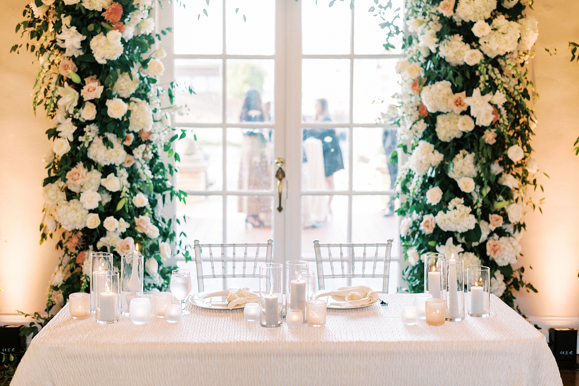 sweetheart table under floral arbor by windows at Separk Mansion