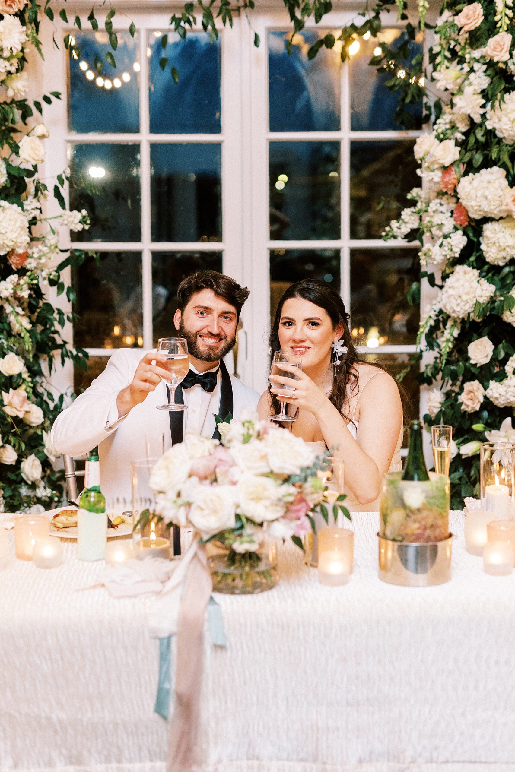newlyweds lift drinks during toast for NC wedding reception 