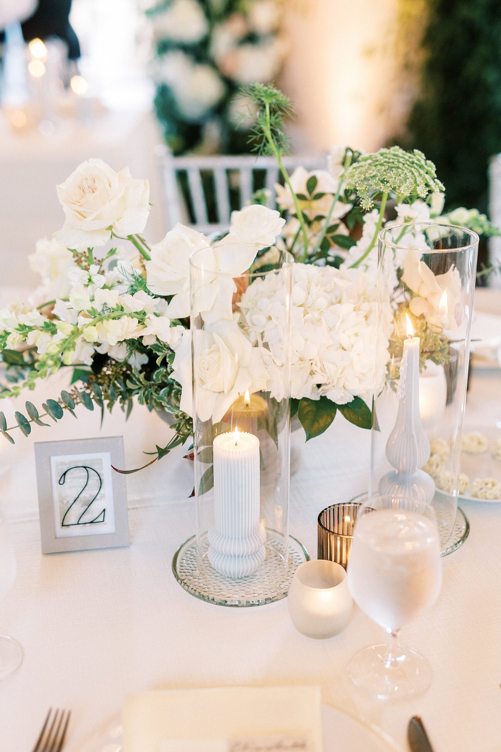 wedding reception centerpiece with white flowers and candles at Separk Mansion