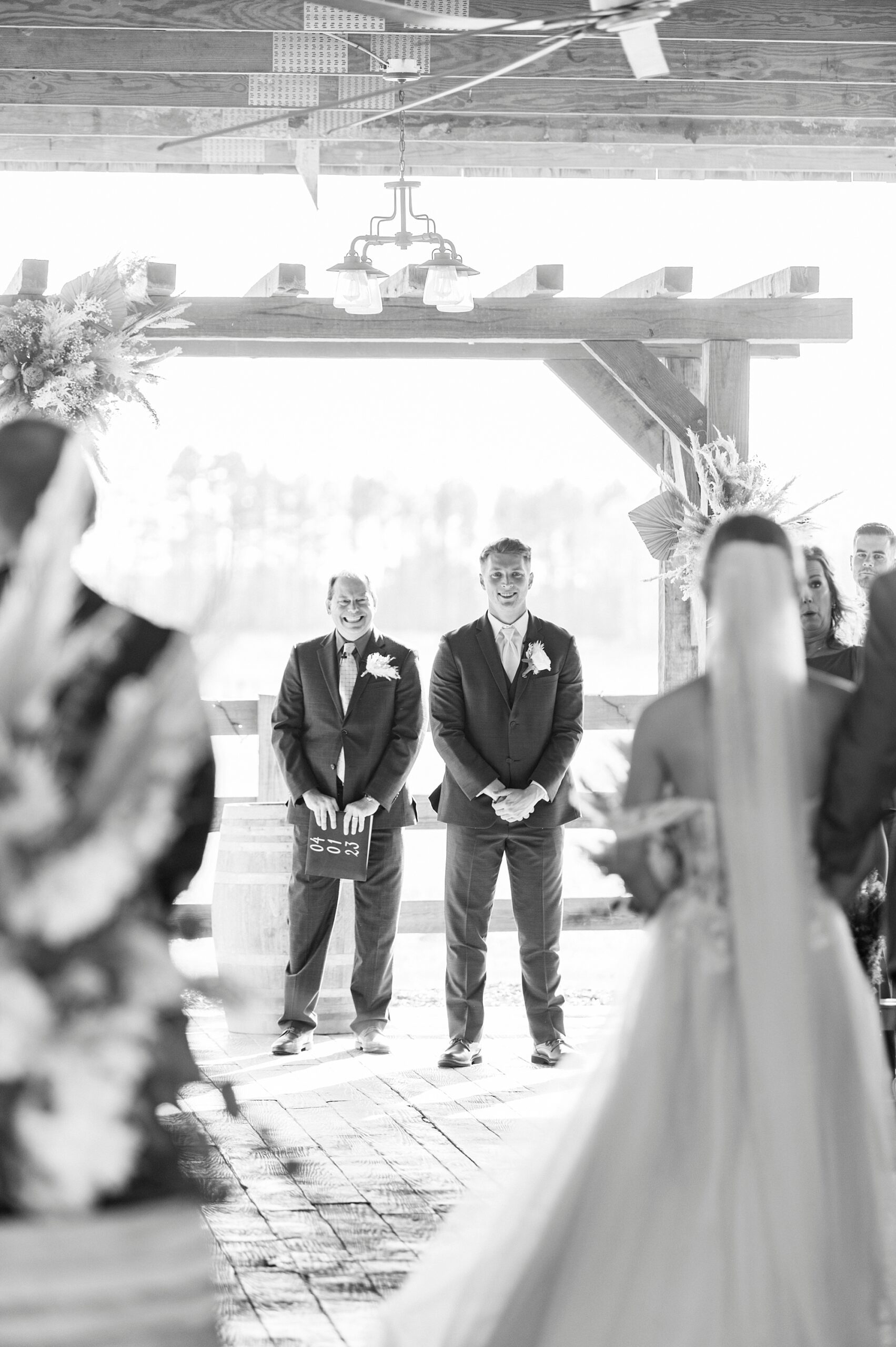 bride walks down aisle to meet groom for wedding ceremony at the Farmstead