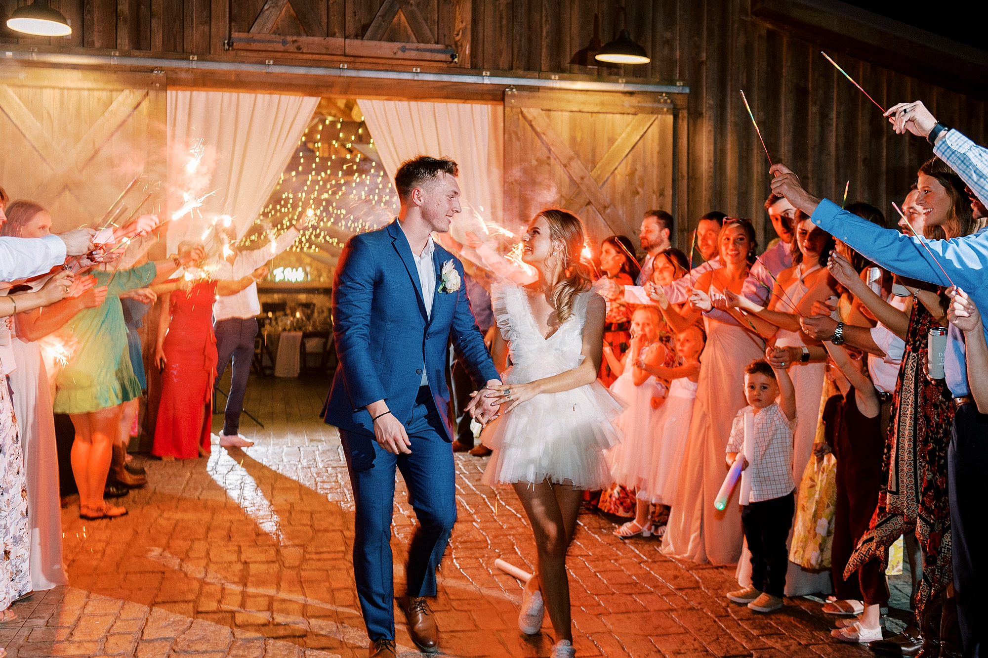 bride and groom walk out of The Farmstead during sparkler exit