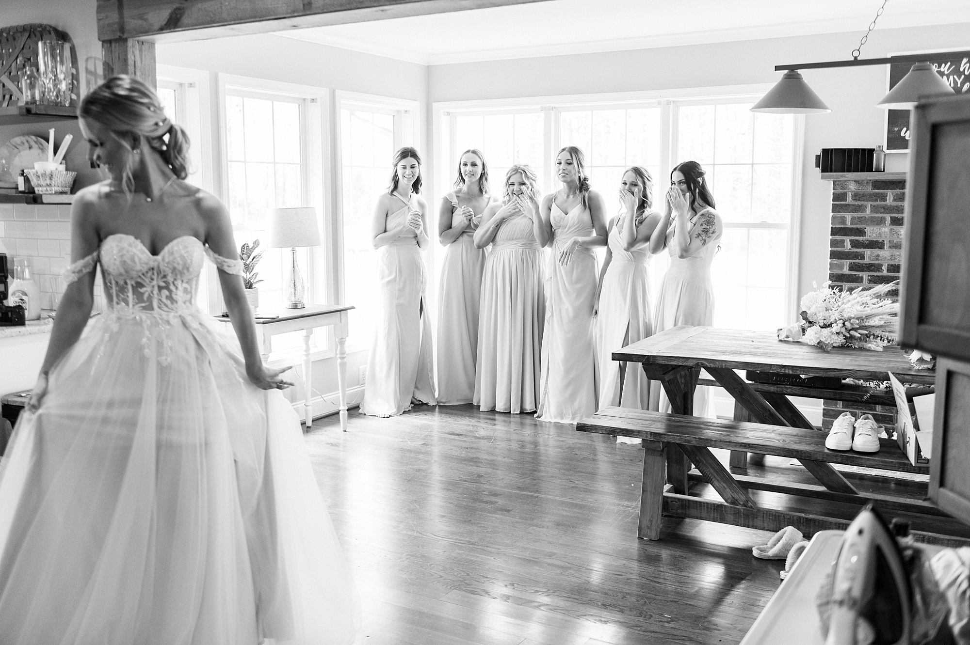 bridesmaids have first look at The Farmstead with bride in corset wedding gown 