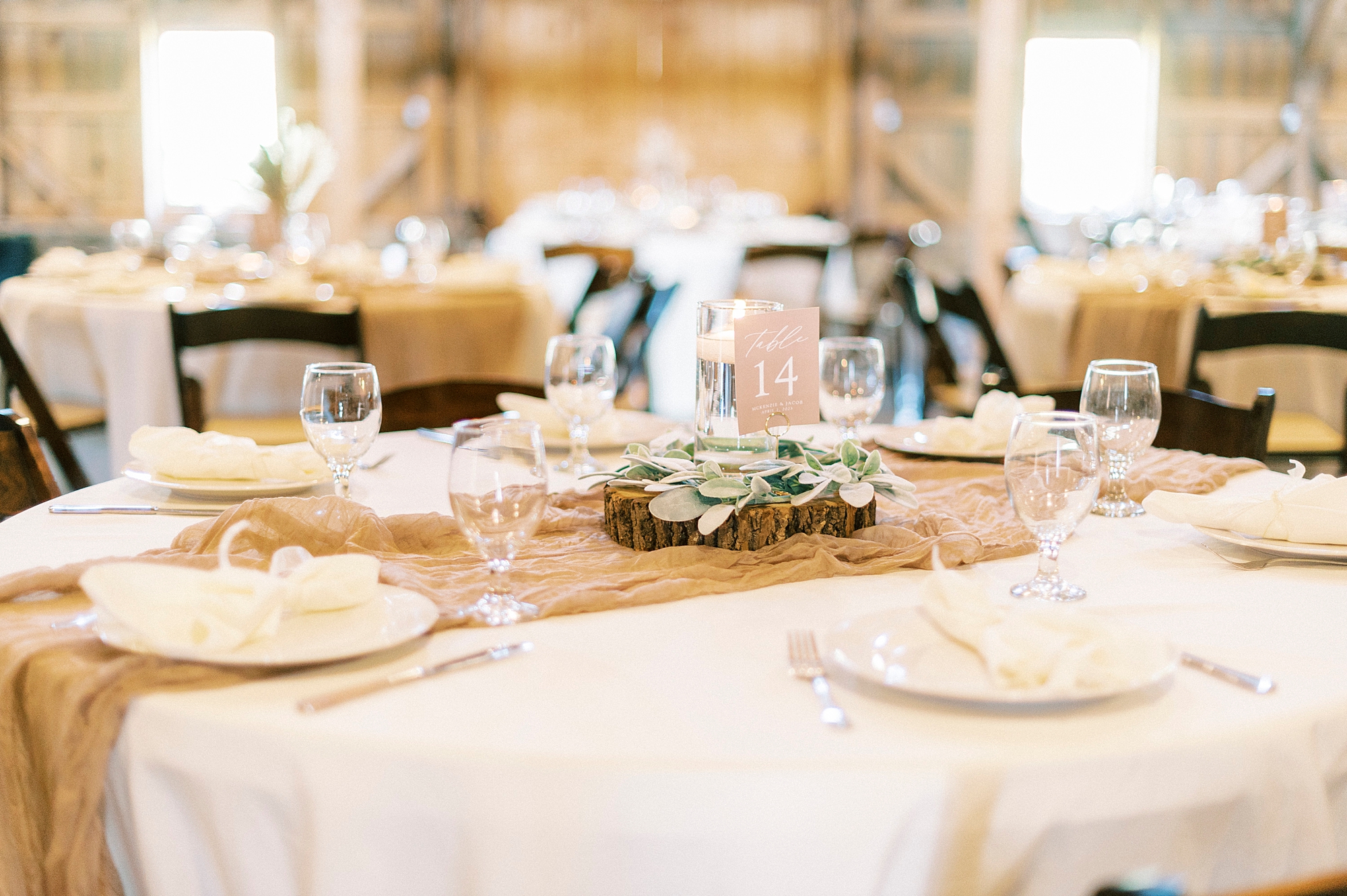 wedding reception with centerpieces on burlap at The Farmstead