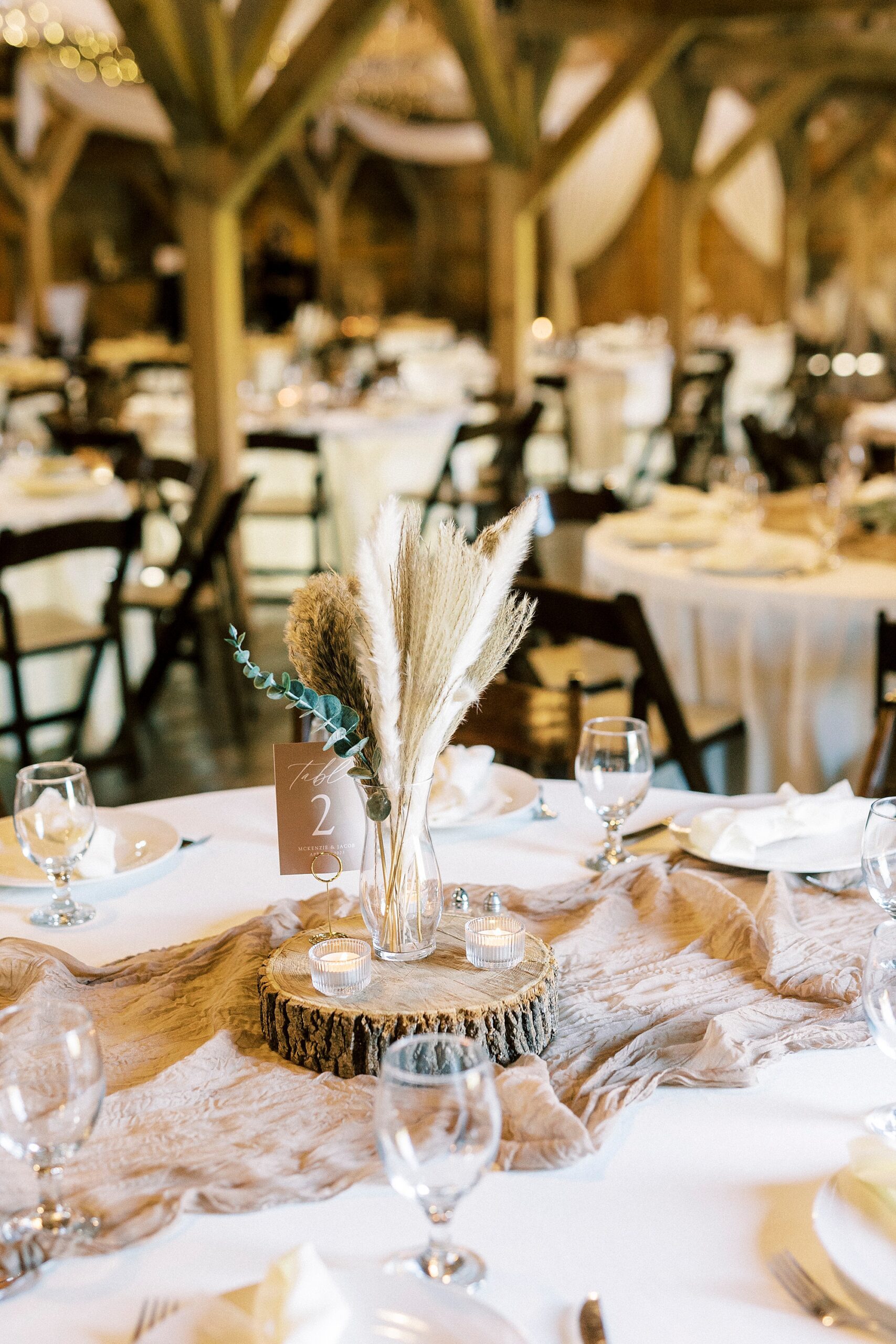 wedding reception at The Farmstead with wood centerpiece at Rhodes grass 