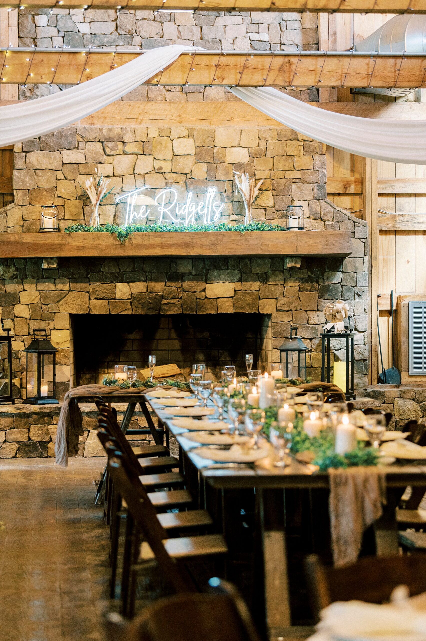 wedding reception at The Farmstead in front of stone fireplace 