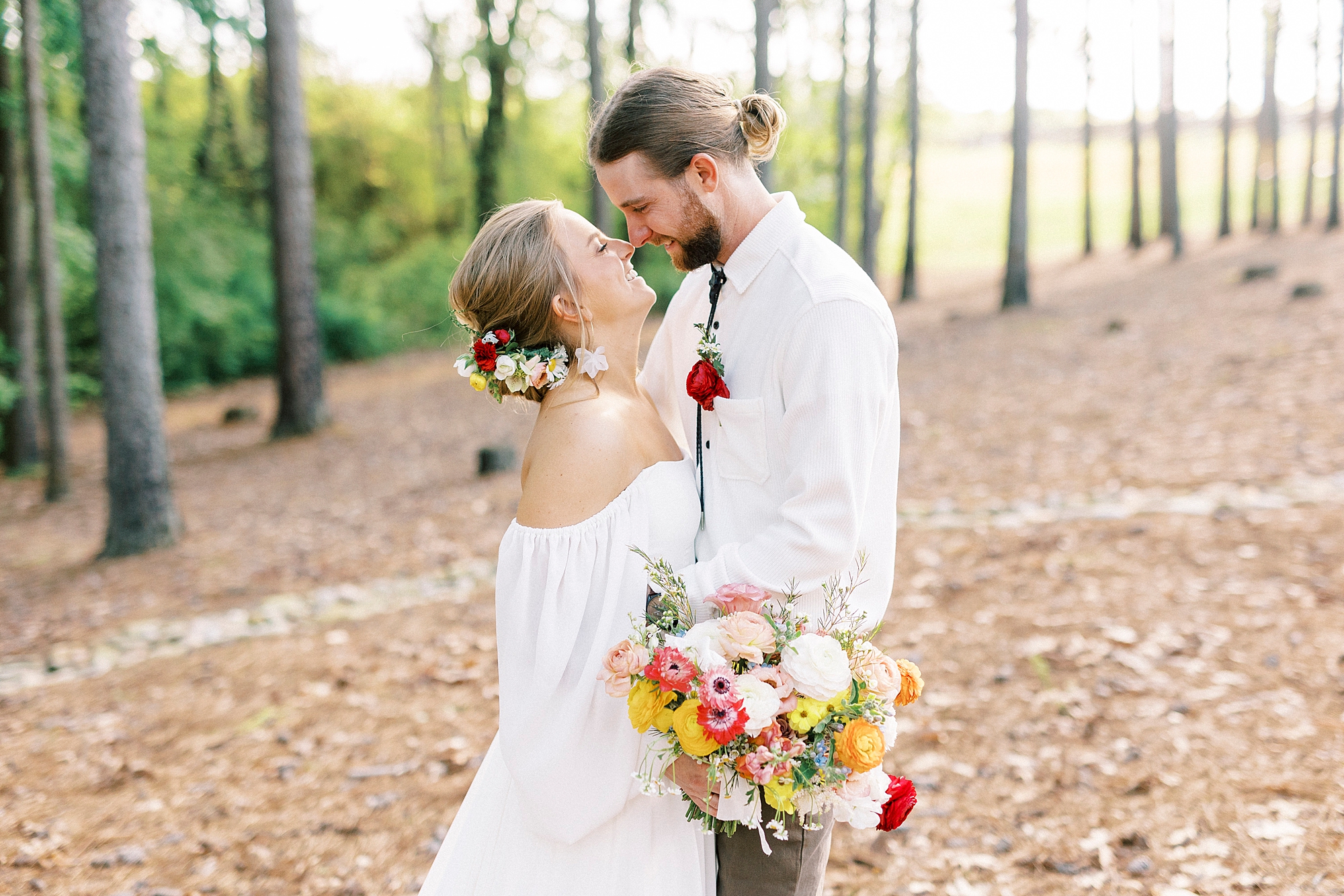 bride and groom smile at each other touching noses during boho inspired wedding day