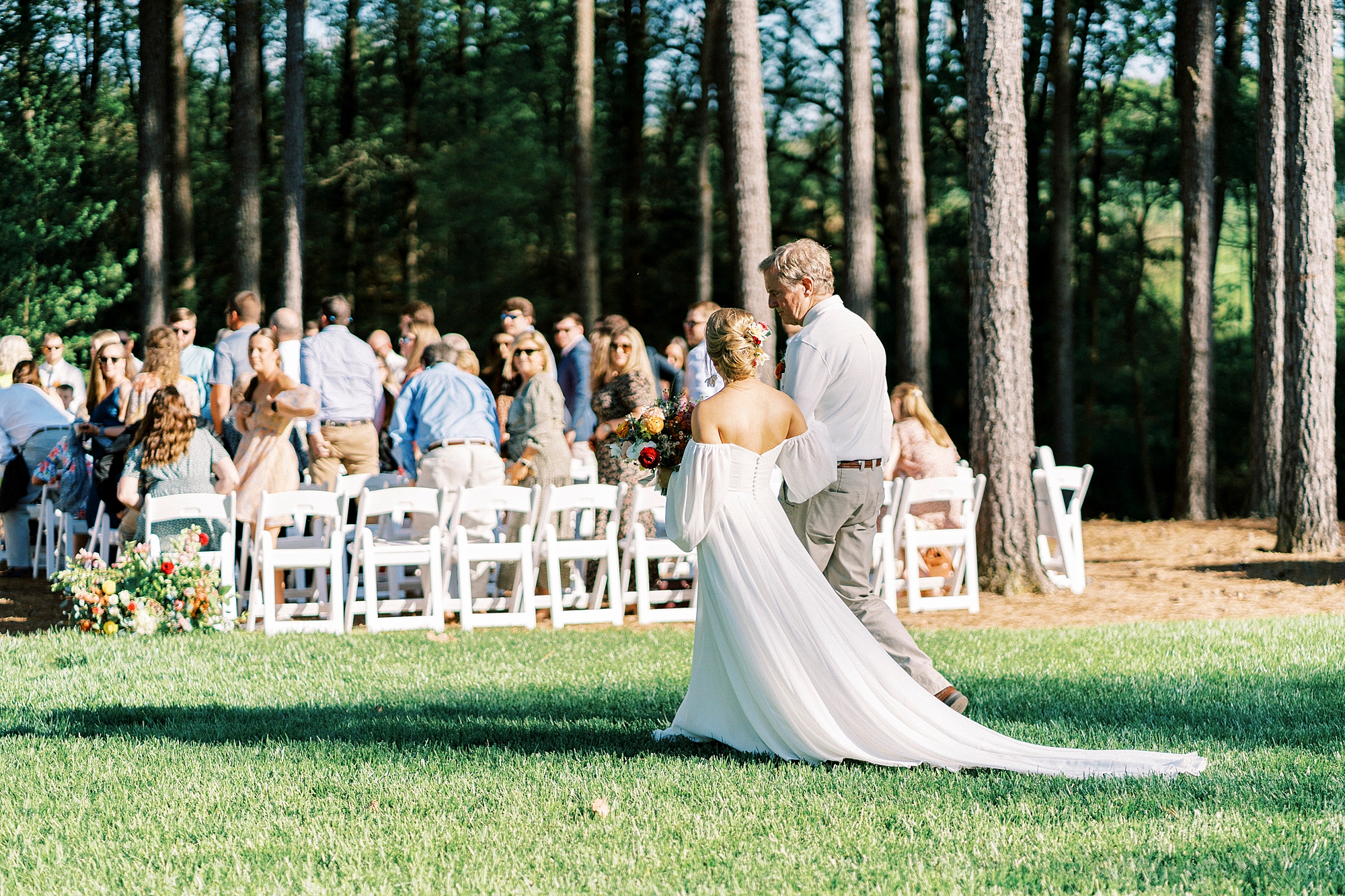 bride enters wedding ceremony on lawn of Richfield NC home with father 