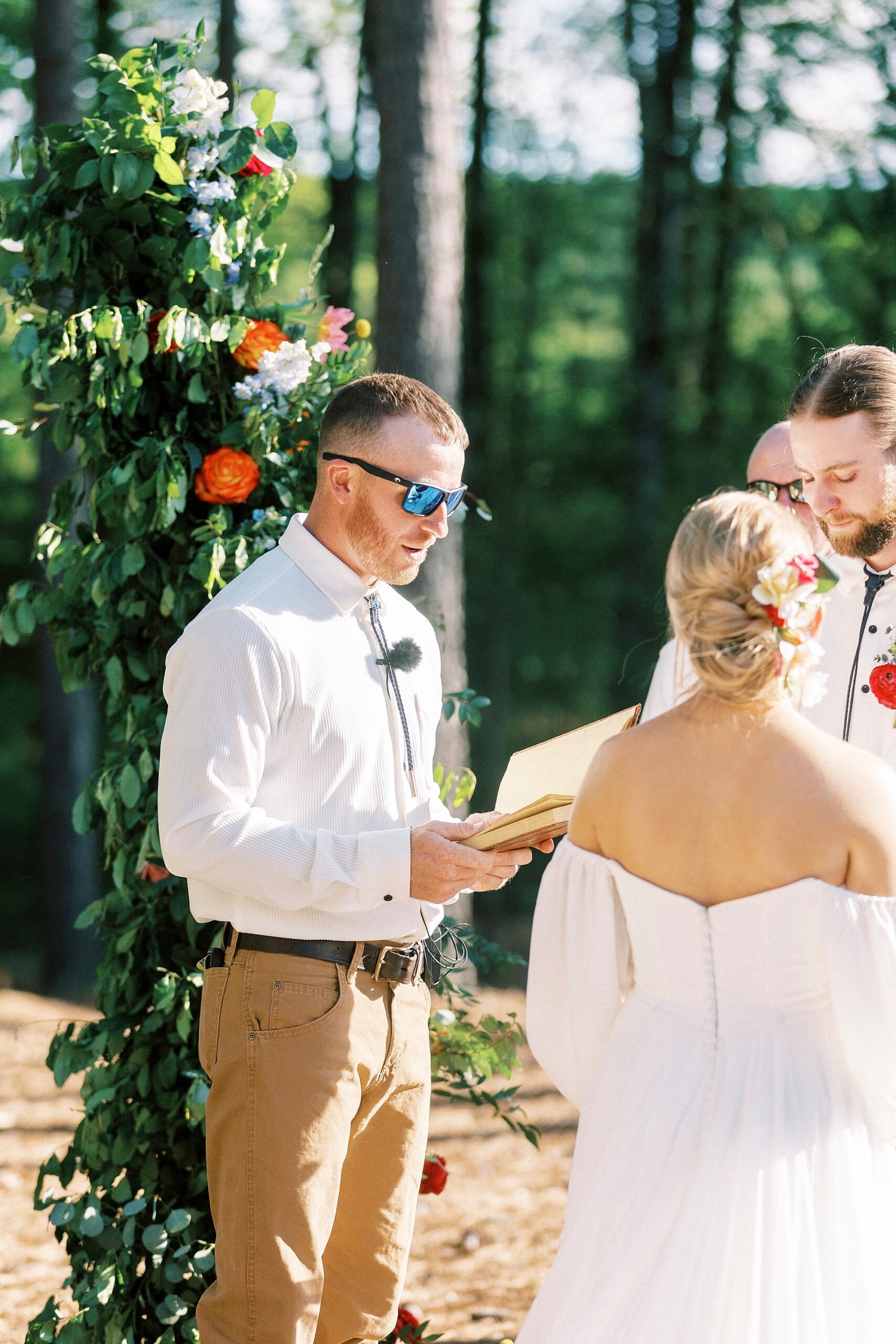 officiant reads during wedding ceremony on lawn of Richfield NC home