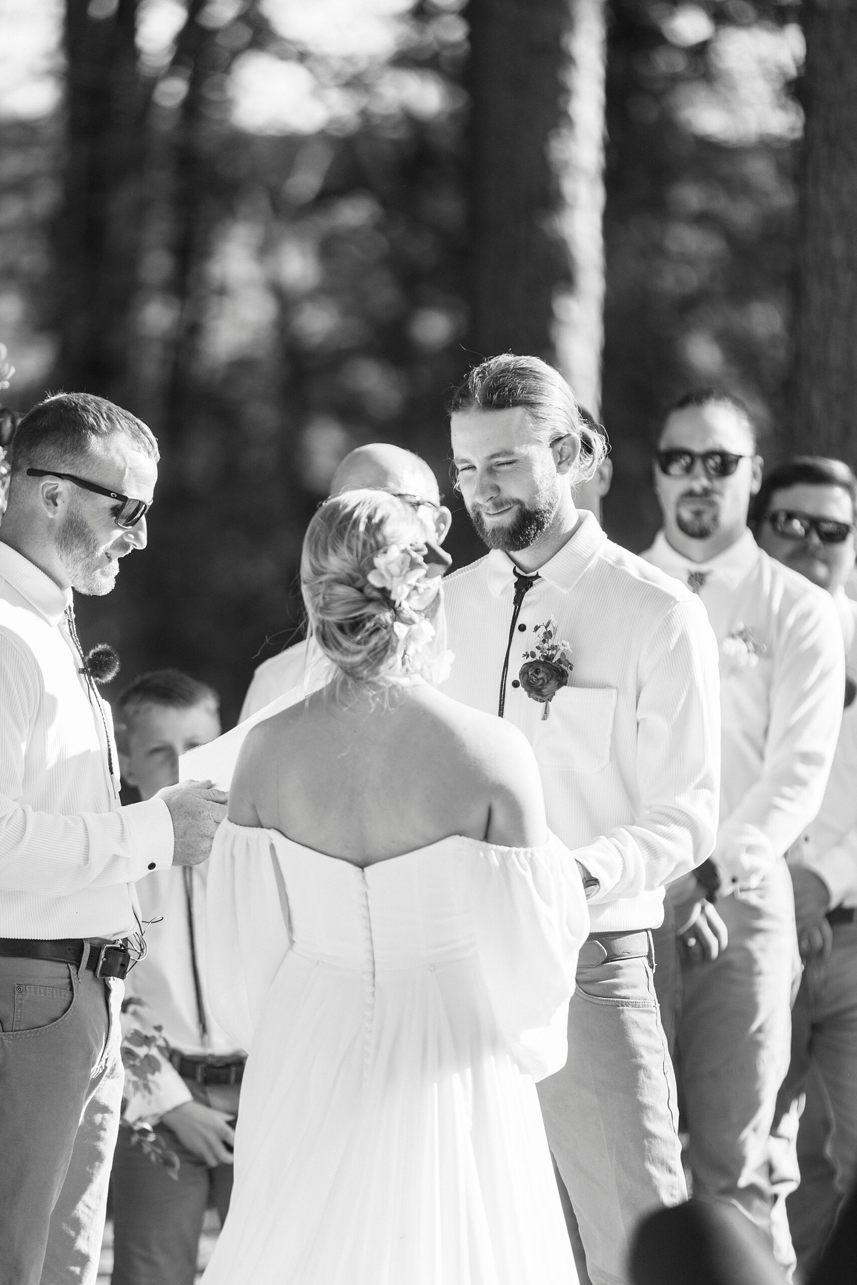 groom looks at bride during wedding ceremony on lawn of Richfield NC home