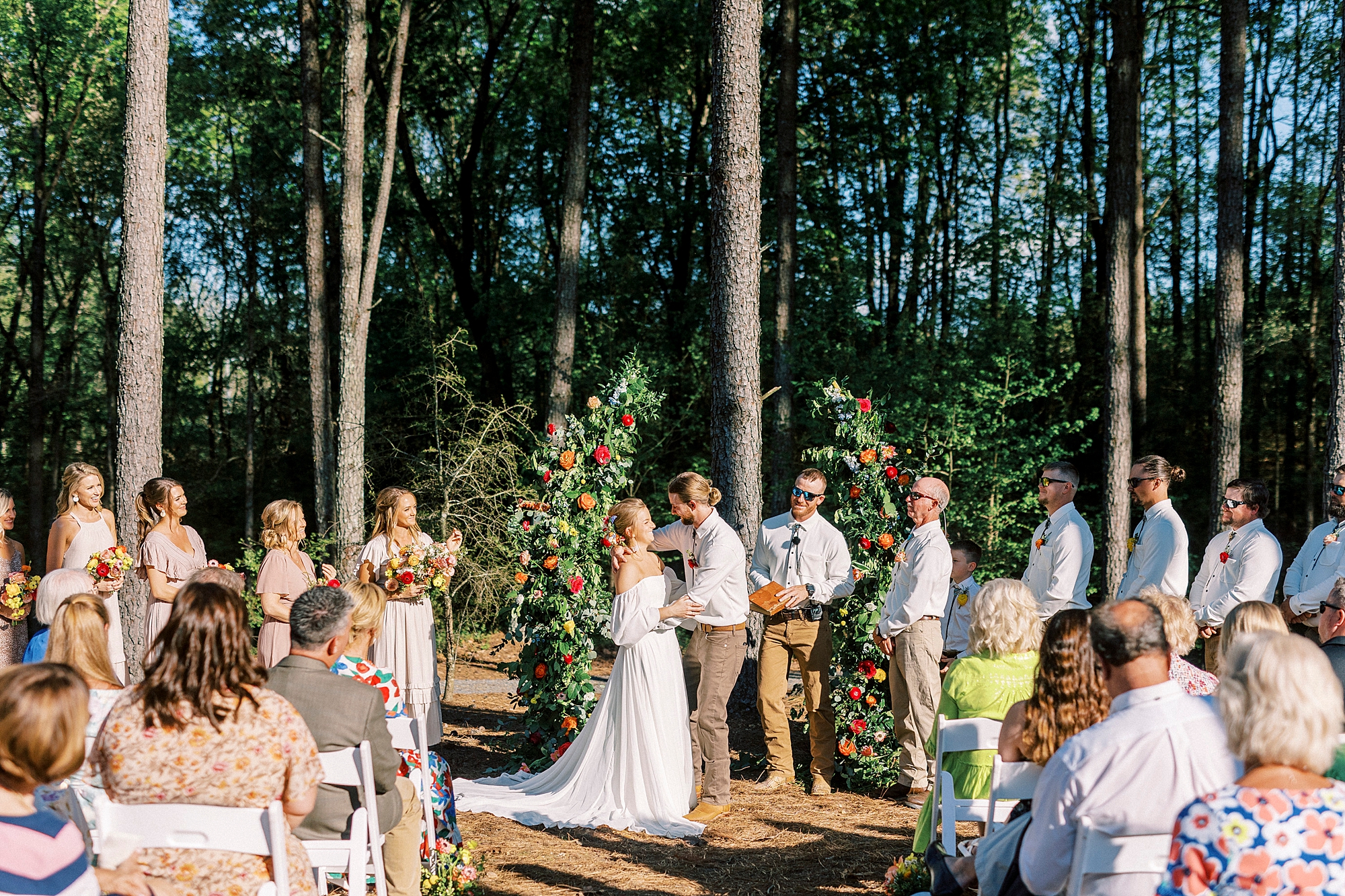 couple exchanges vows during wedding ceremony on lawn of Richfield NC home